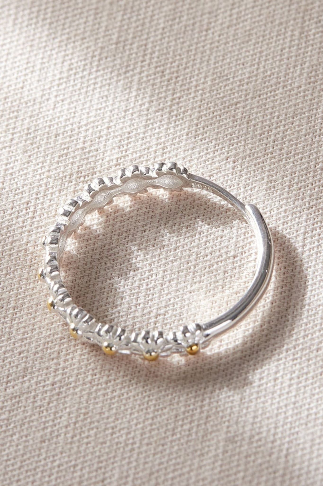 sterling-silver-daisy-chain-ring-lying-flat