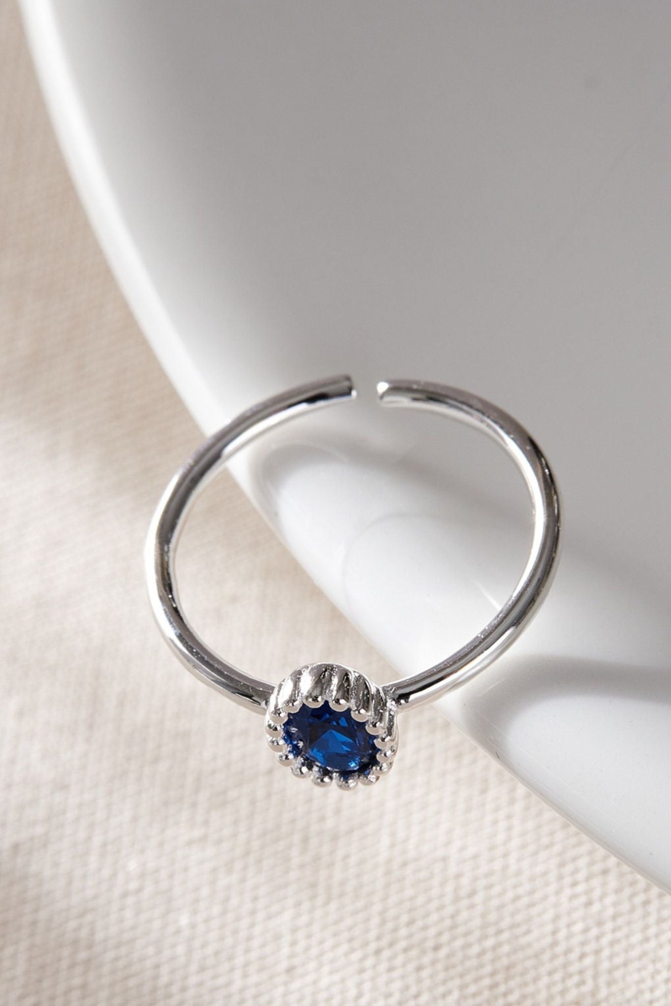 sterling-silver-blue-zirconia-ring-lying-flat