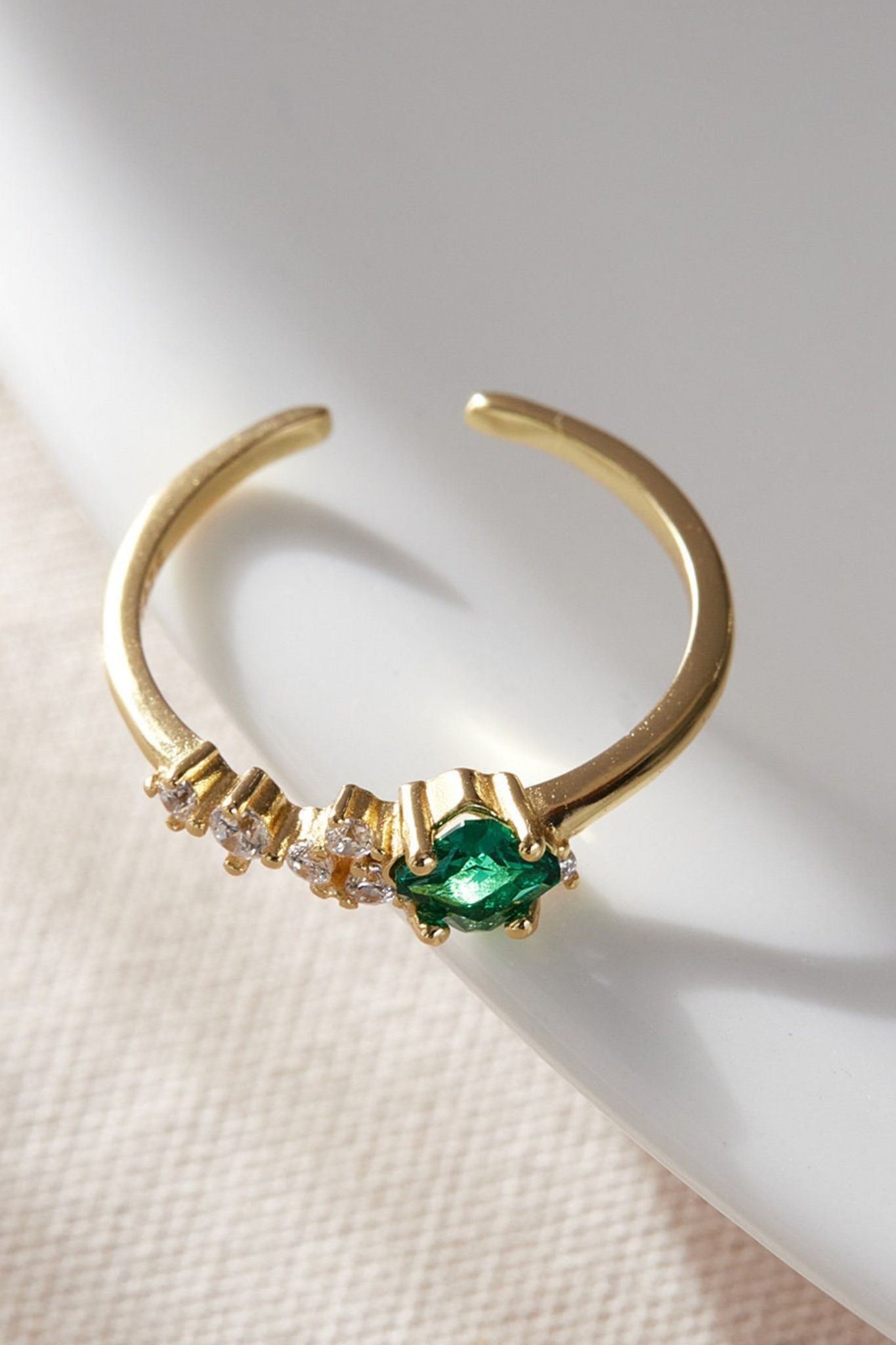 sterling-silver-cz-emerald-green-ring-lying-flat