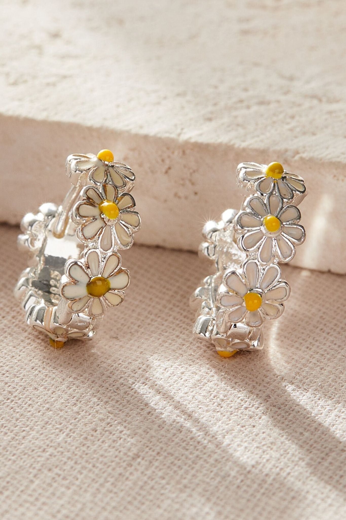 silver-daisy-huggie-hoops-closeup