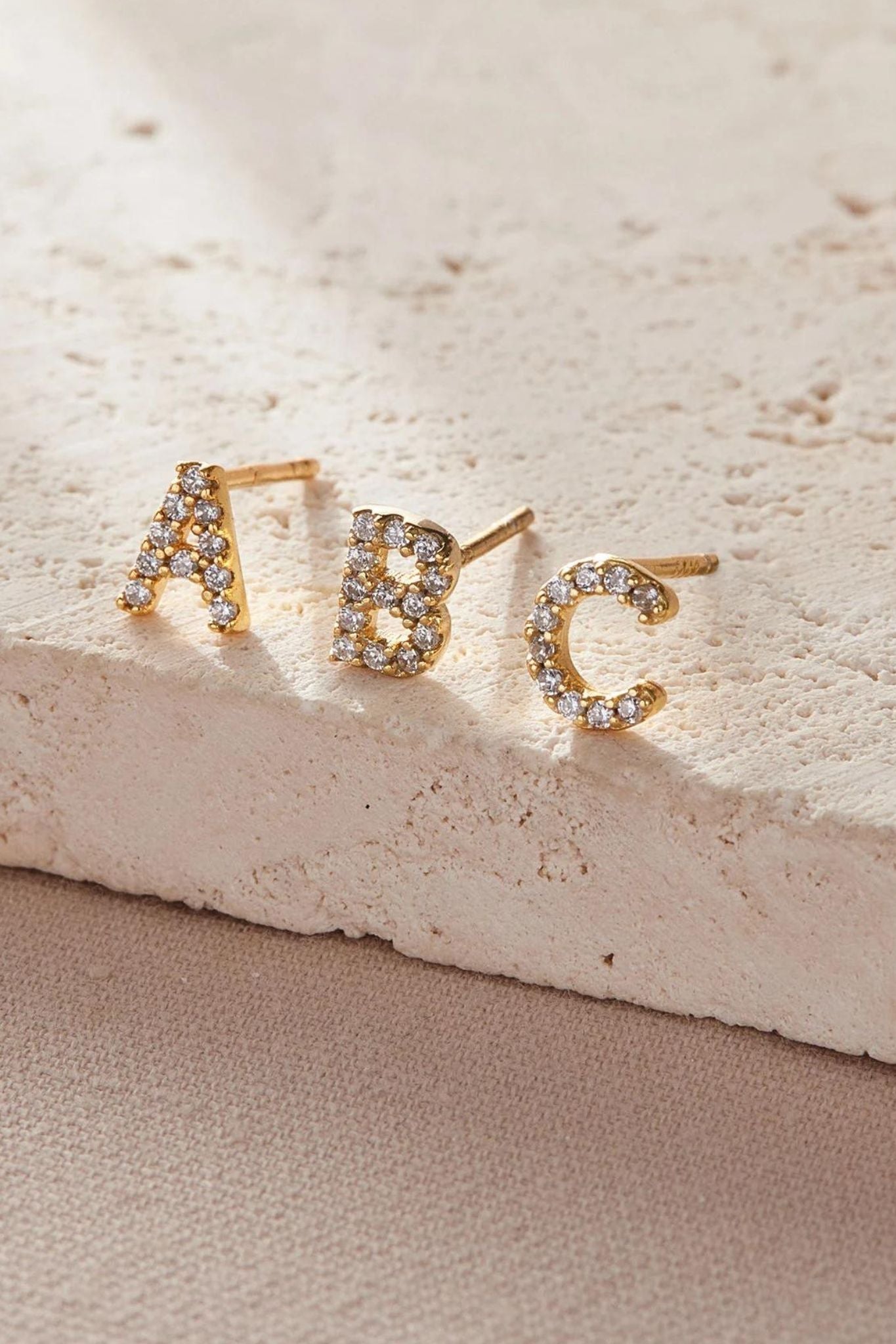 sterling-silver-cz-alphabet-studs-in-gold-single-earrings-closeup
