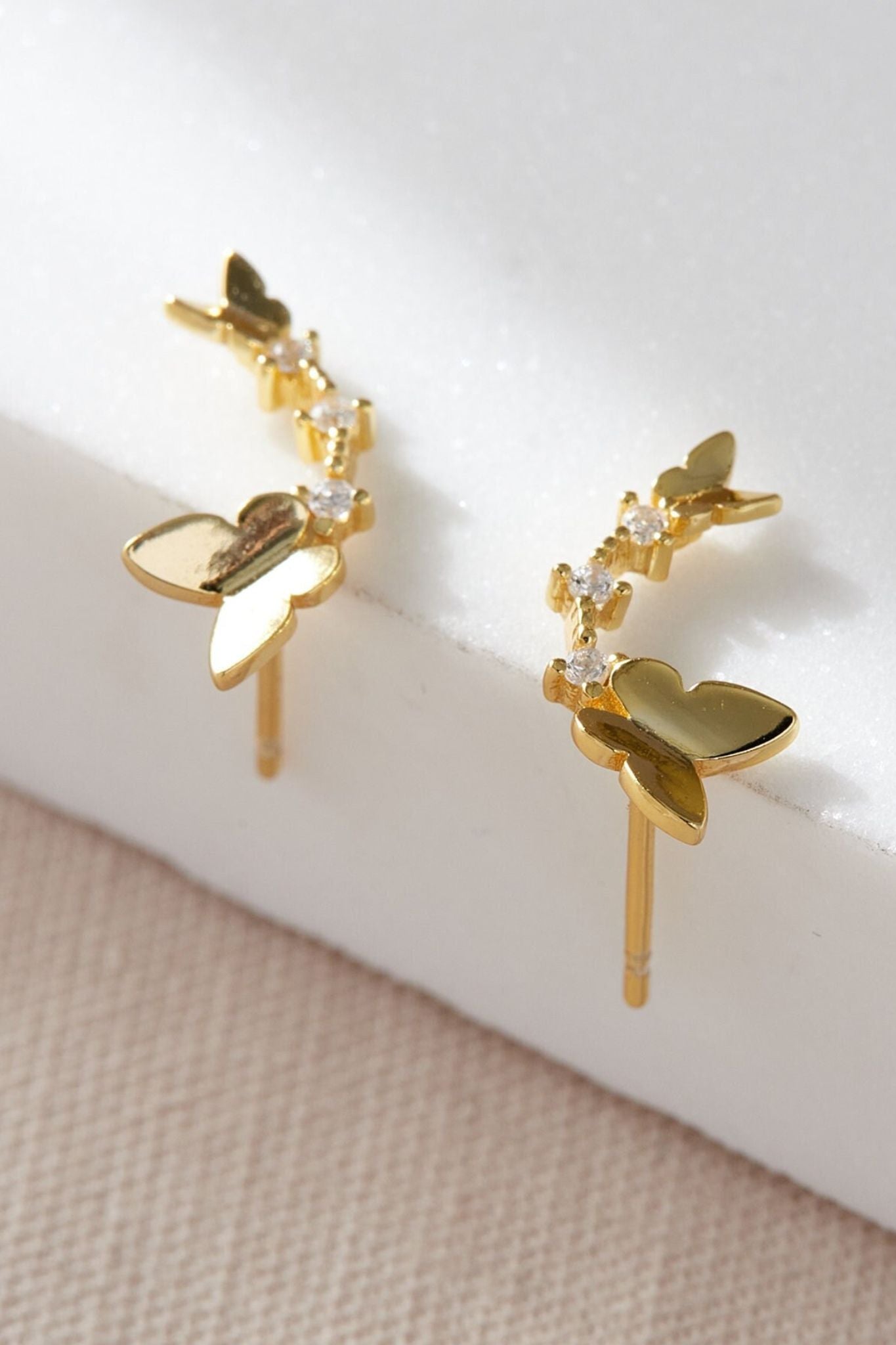 sterling-silver-cz-dual-butterfly-studs-in-gold-closeup
