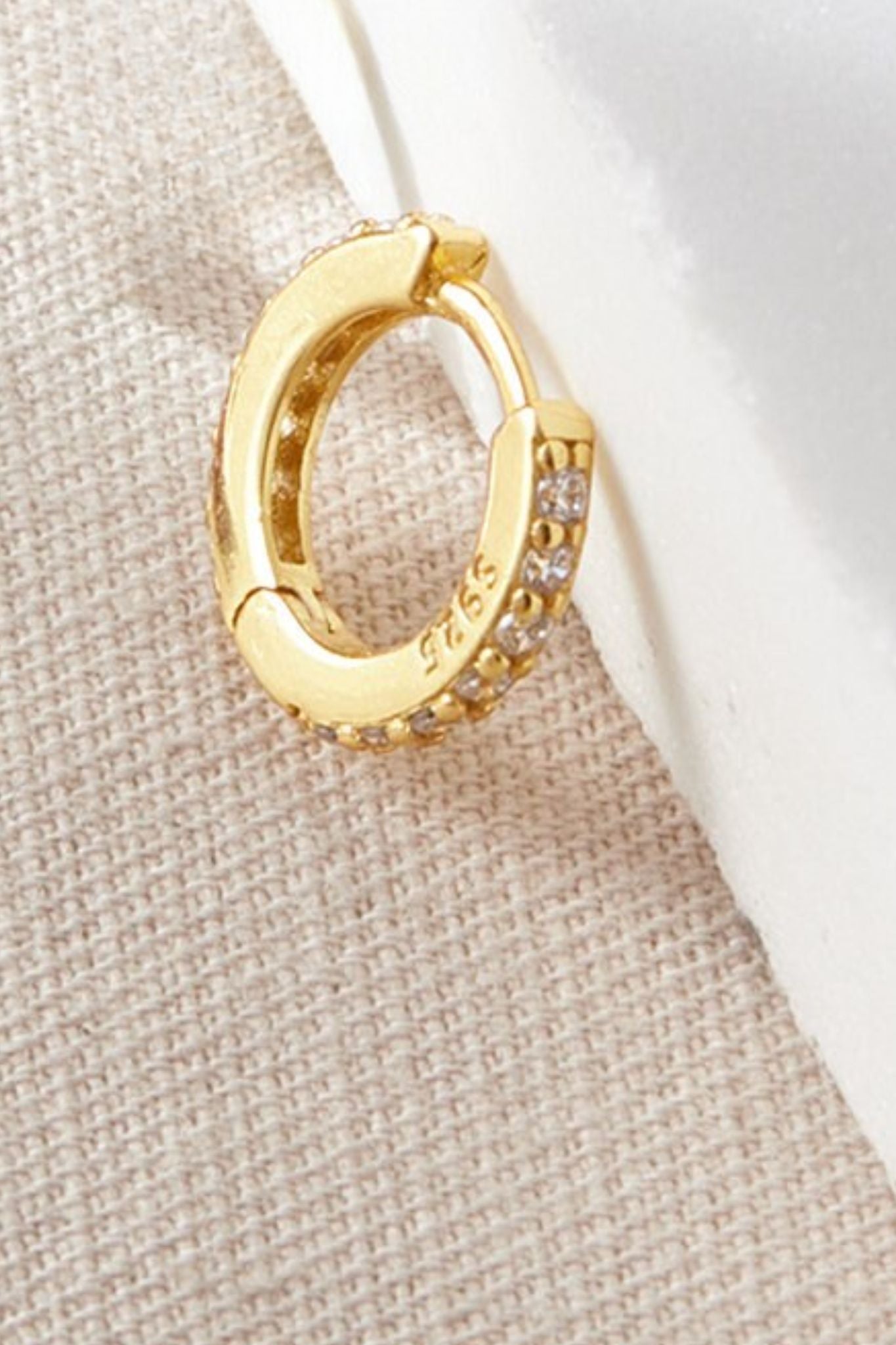 sterling-silver-cz-huggie-hoops-in-gold-white-closeup