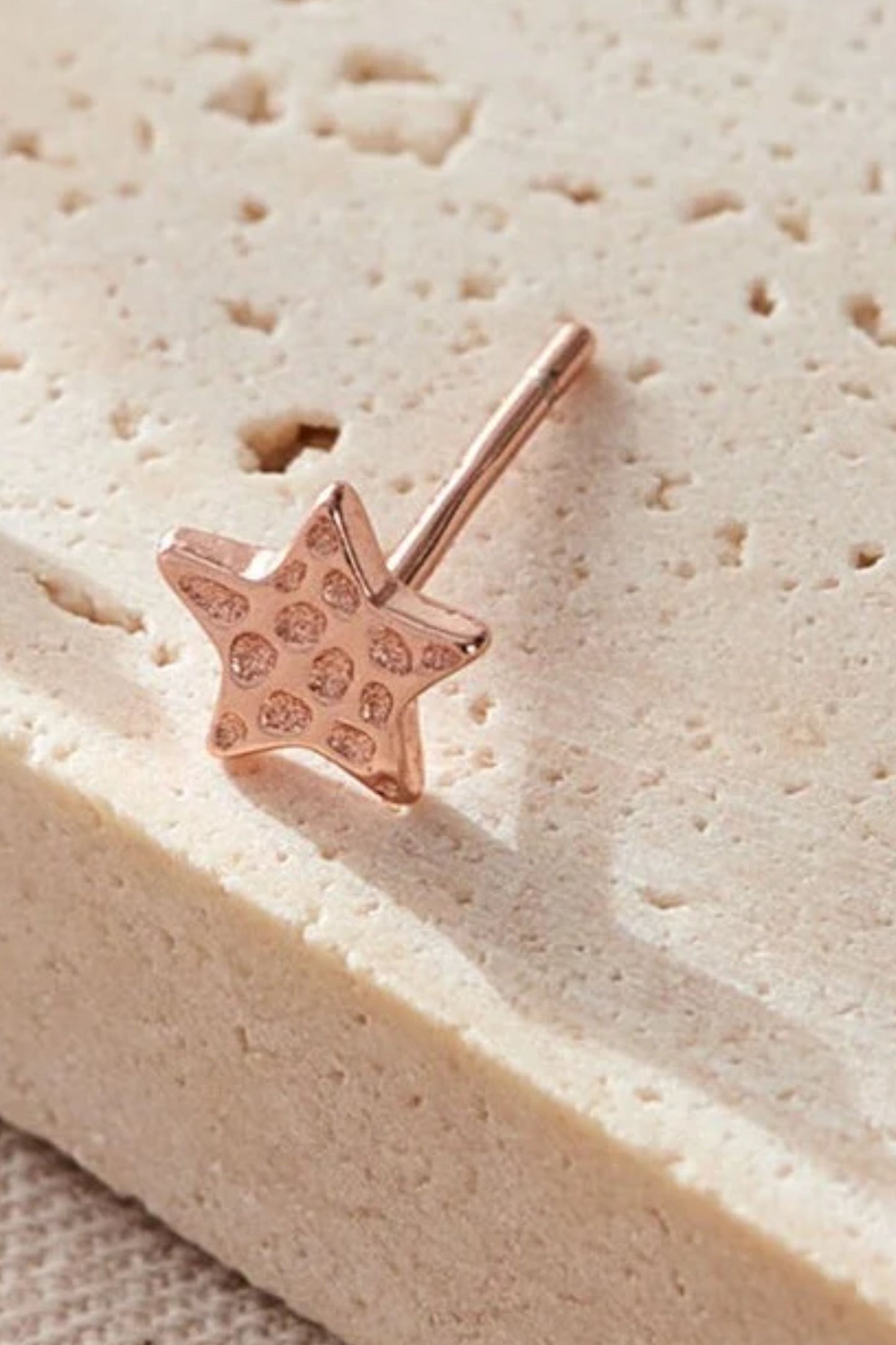 sterling-silver-hammered-star-studs-6mm-in-rose-gold-closeup