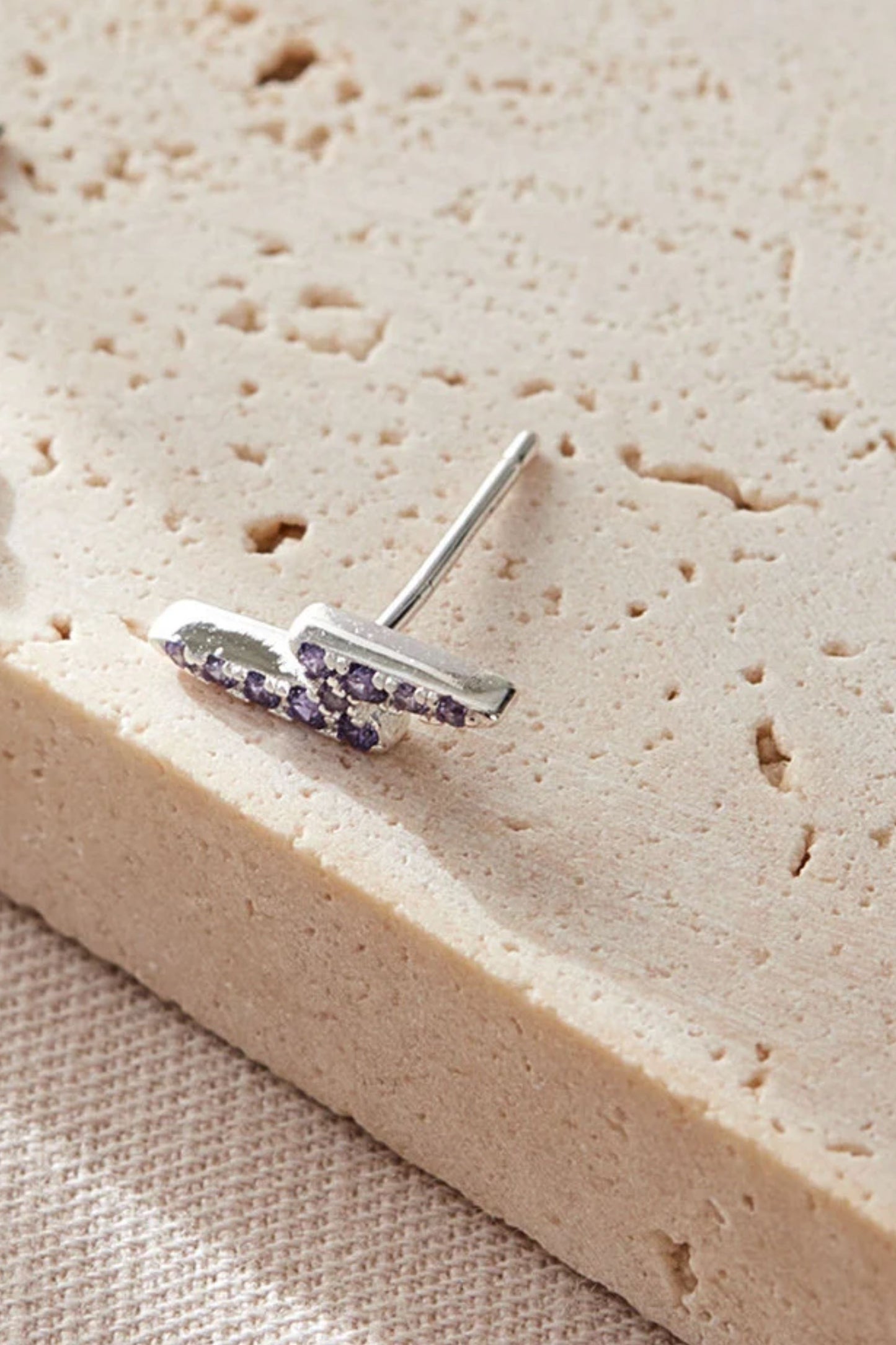 sterling-silver-cz-lightning-bolt-studs-in-silver-purple-closeup