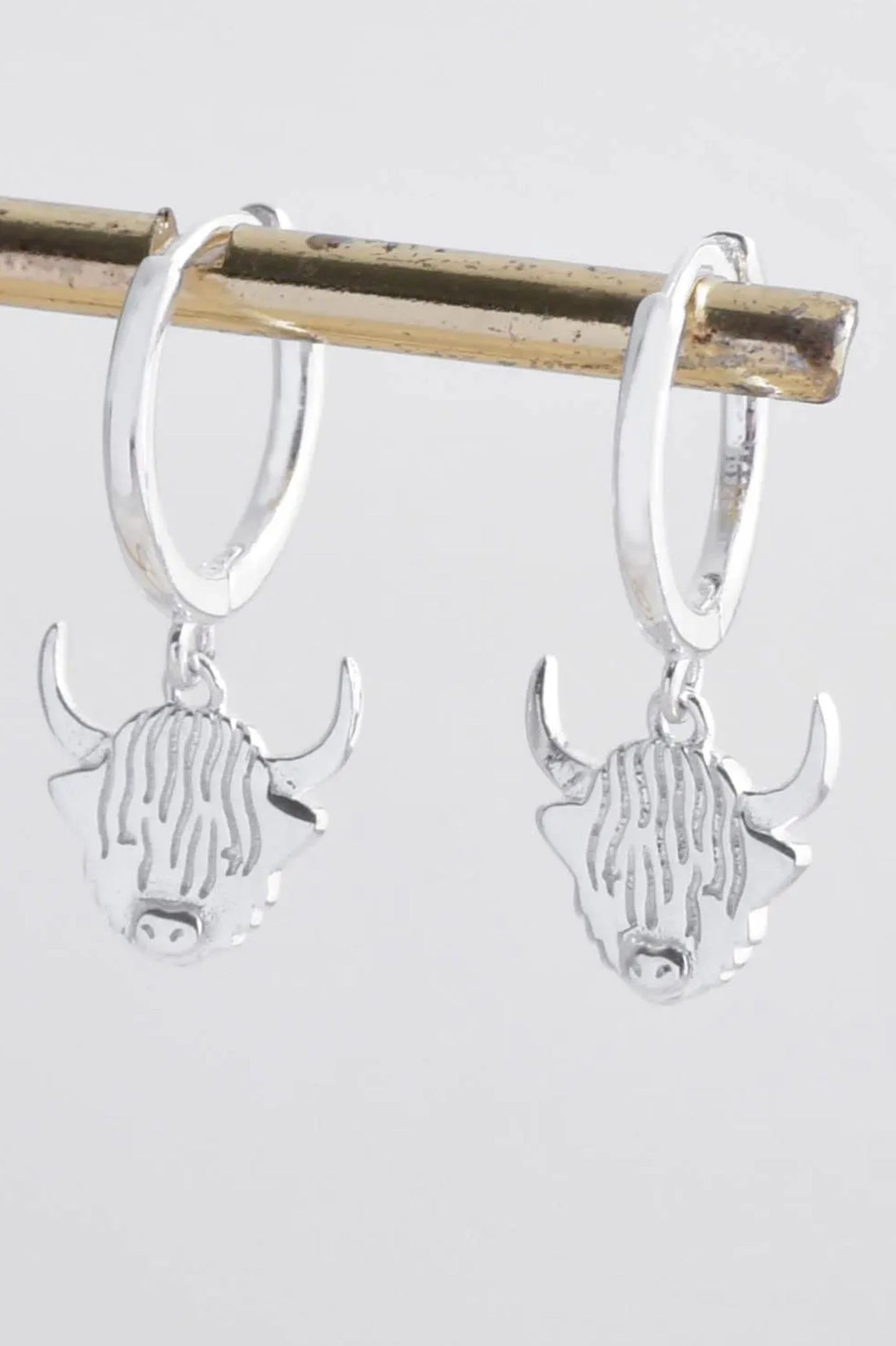 highland-cow-huggie-hoops-in-silver-closeup