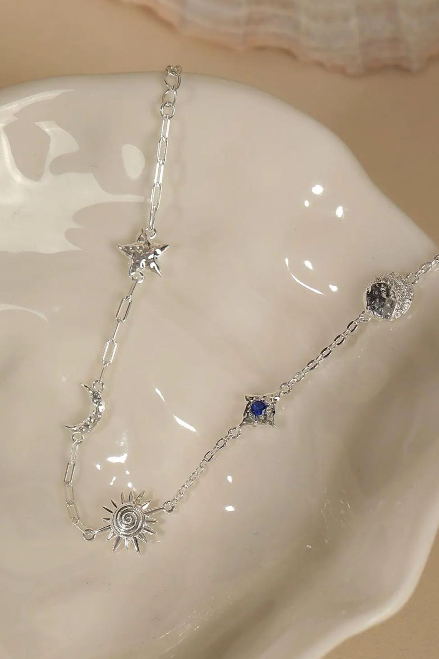 sterling-silver-sun-moon-star-charm-bracelet-in-silver-closeup