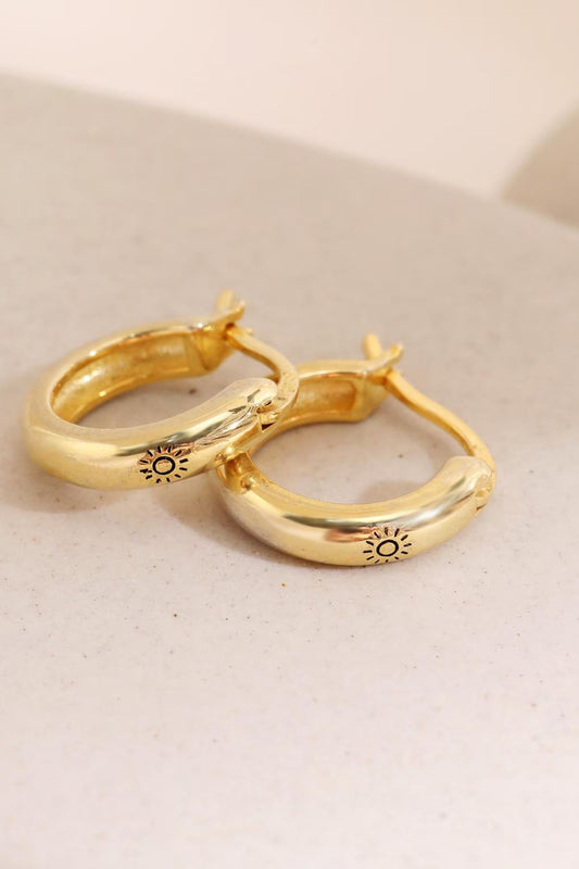 sterling-silver-engraved-sun-hoops-in-gold-closeup