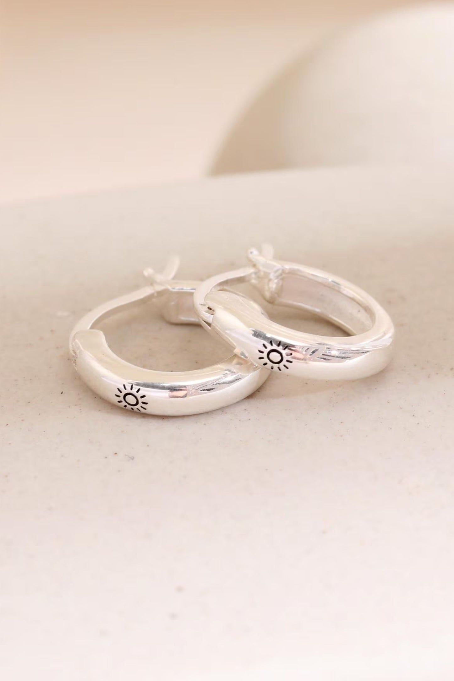 sterling-silver-engraved-sun-hoops-in-silver-closeup