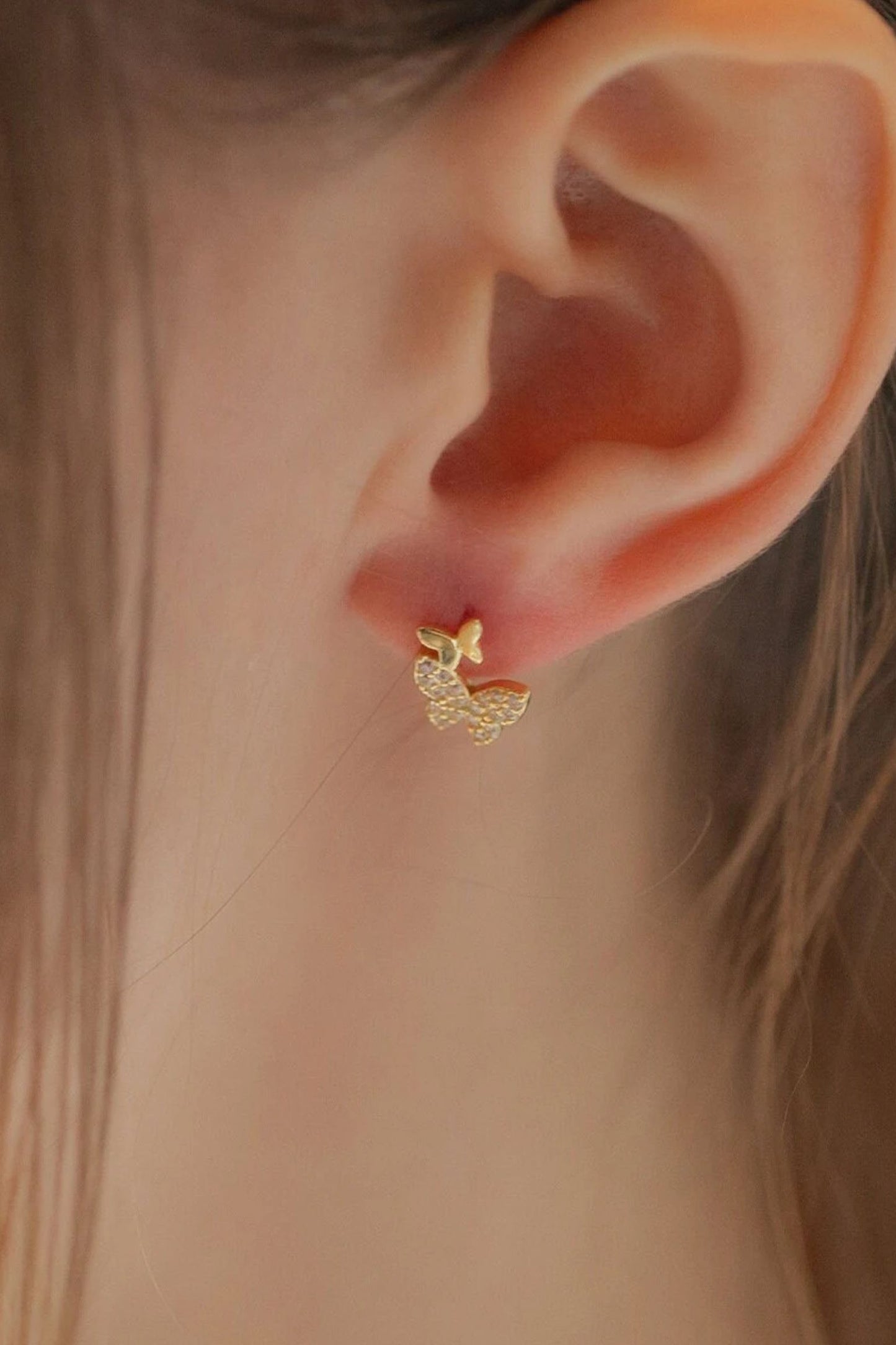sterling-silver-sparkly-butterfly-studs-in-gold-model
