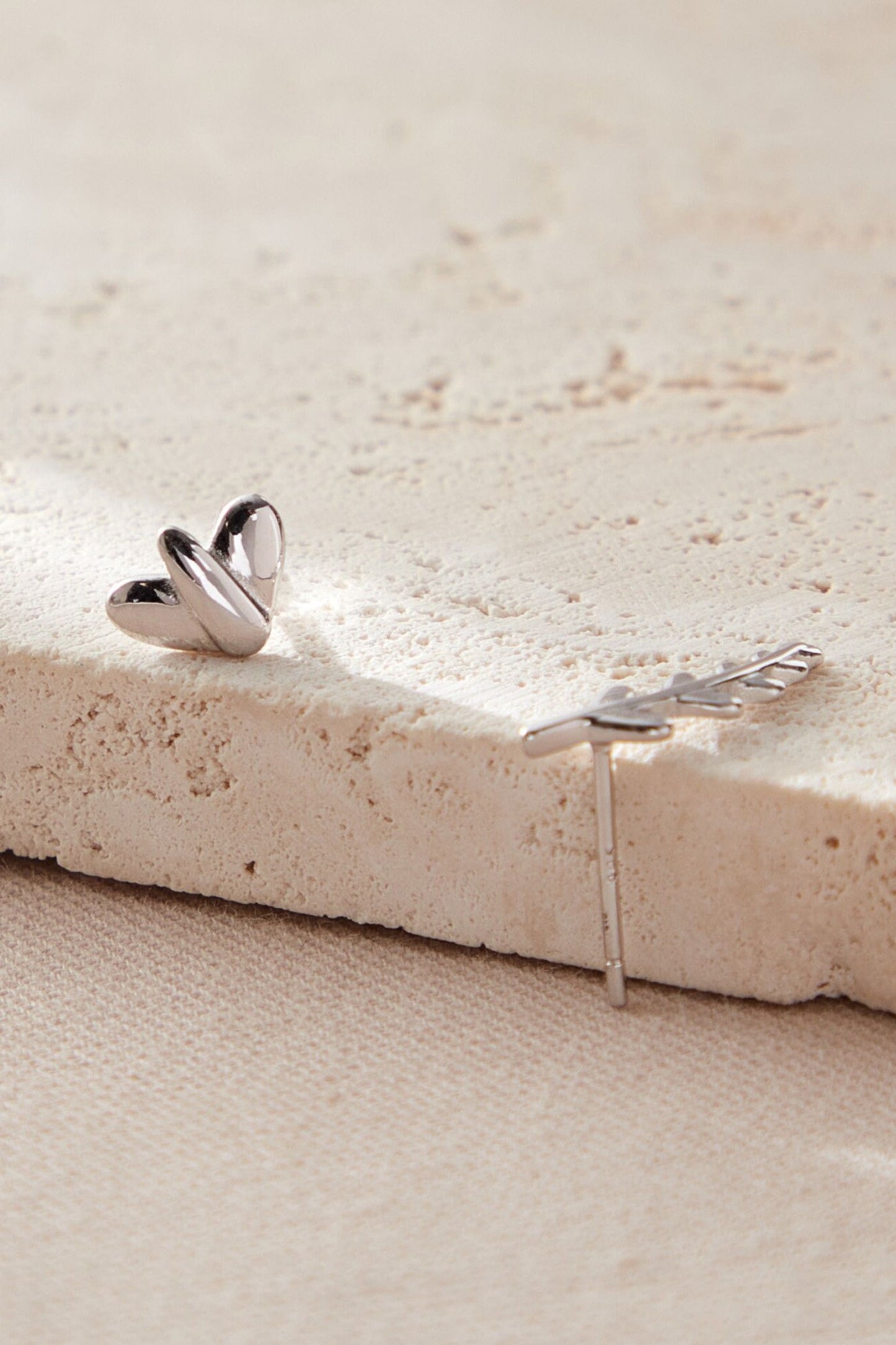 sterling-silver-mismatched-leaf-studs-in-silver-closeup