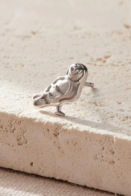 close up of the silver barn owl earring, showing the detail of the design