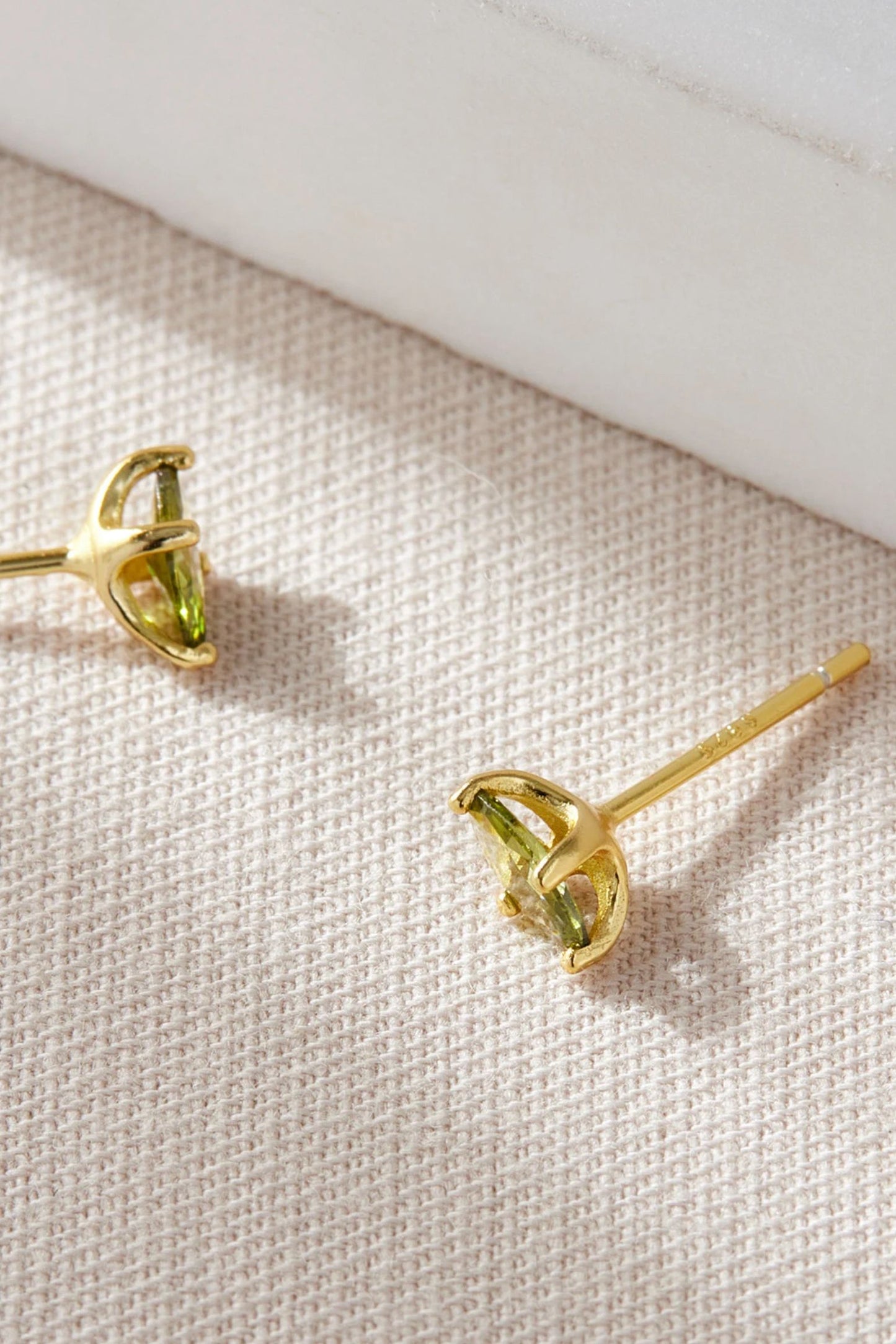 sterling-silver-olive-green-oval-studs-in-gold-closeup