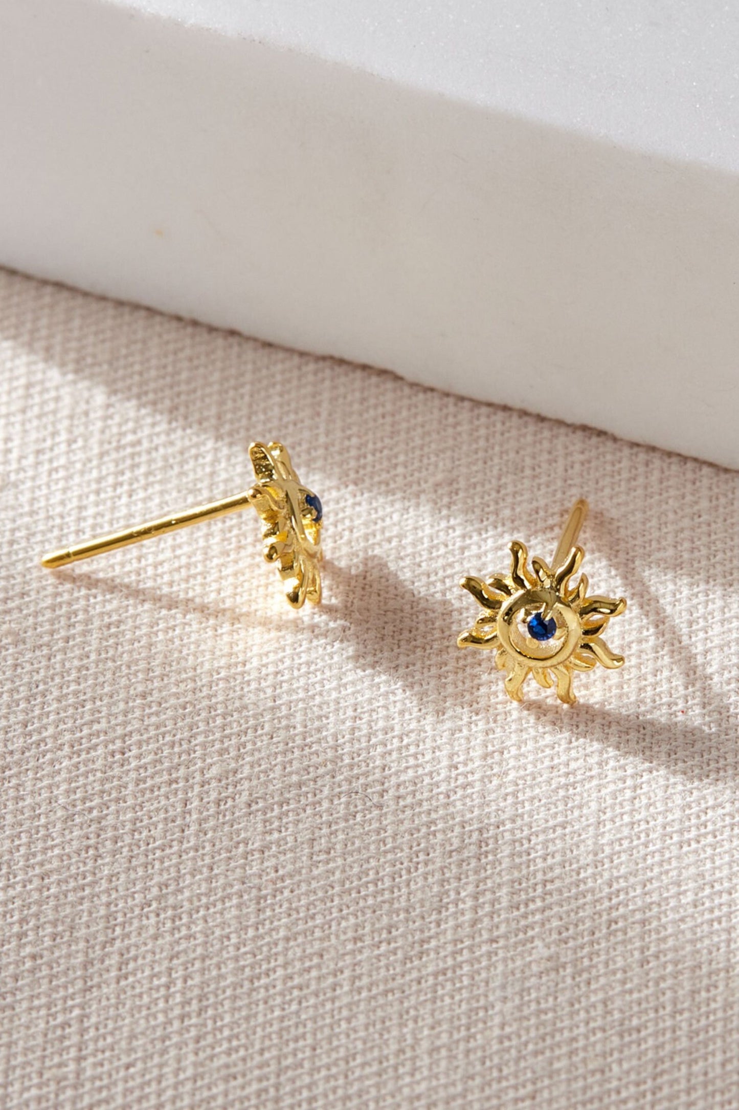 sterling-silver-sun-studs-in-gold-closeup