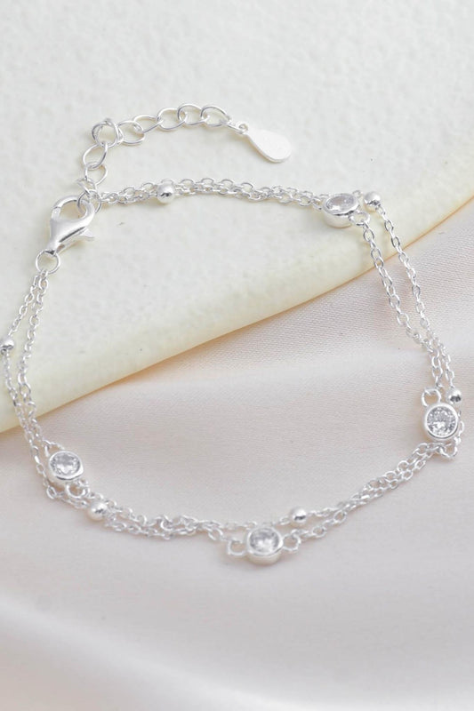 sterling-silver-round-cz-charm-bracelet-lying-flat