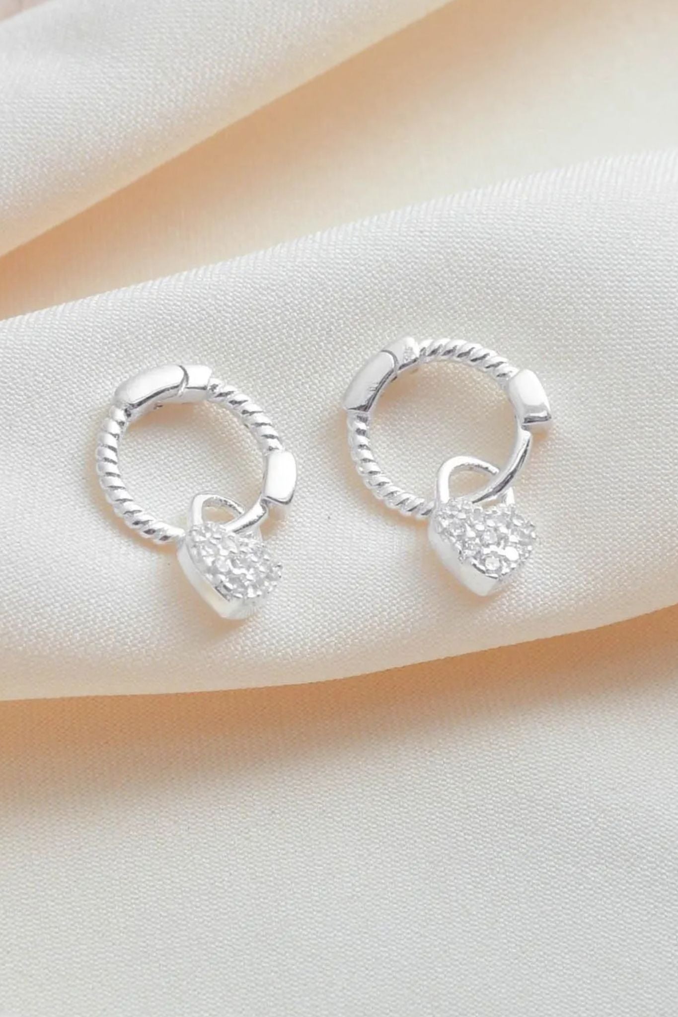 sterling-silver-cz-heart-huggie-hoops-closeup