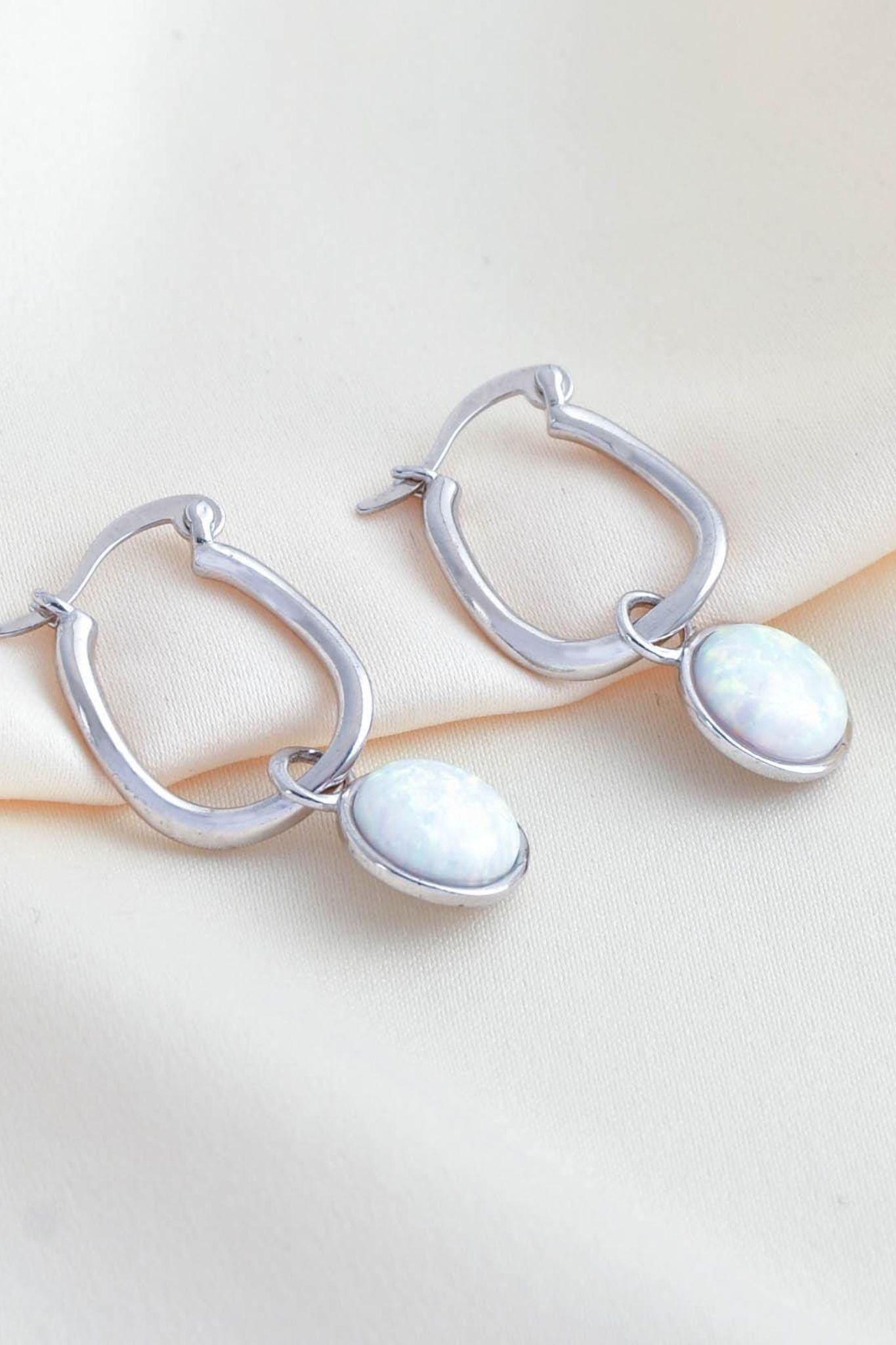 sterling-silver-opal-hoops-lying-flat