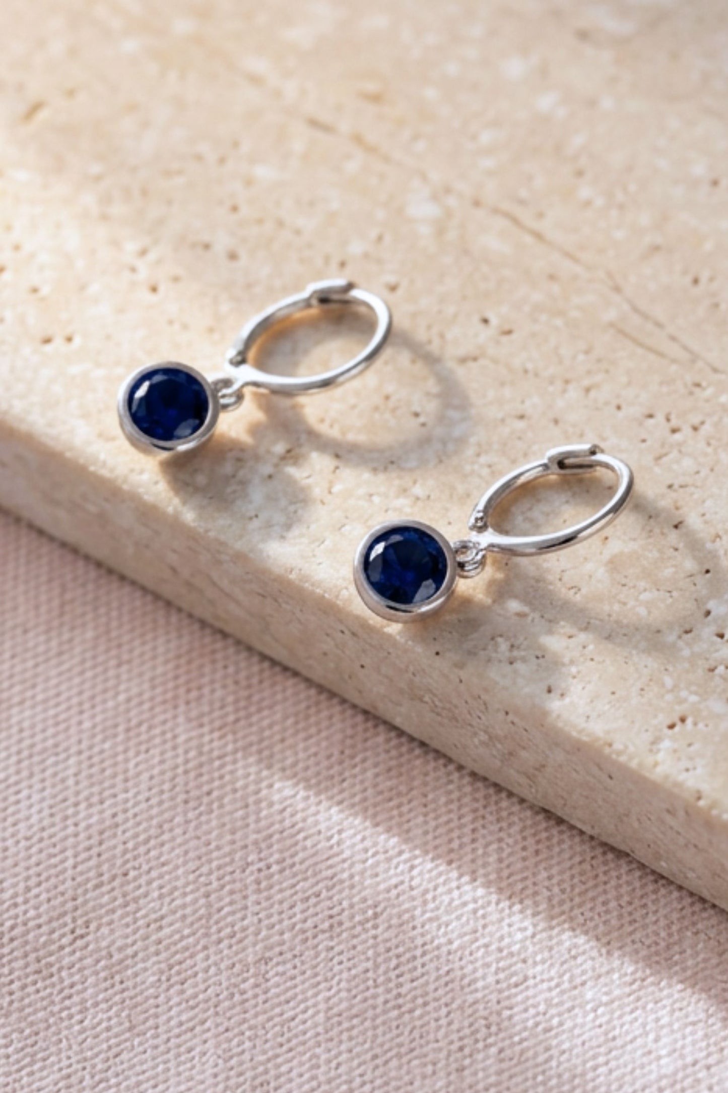 sterling-silver-cz-huggie-hoops-in-silver-midnight-blue