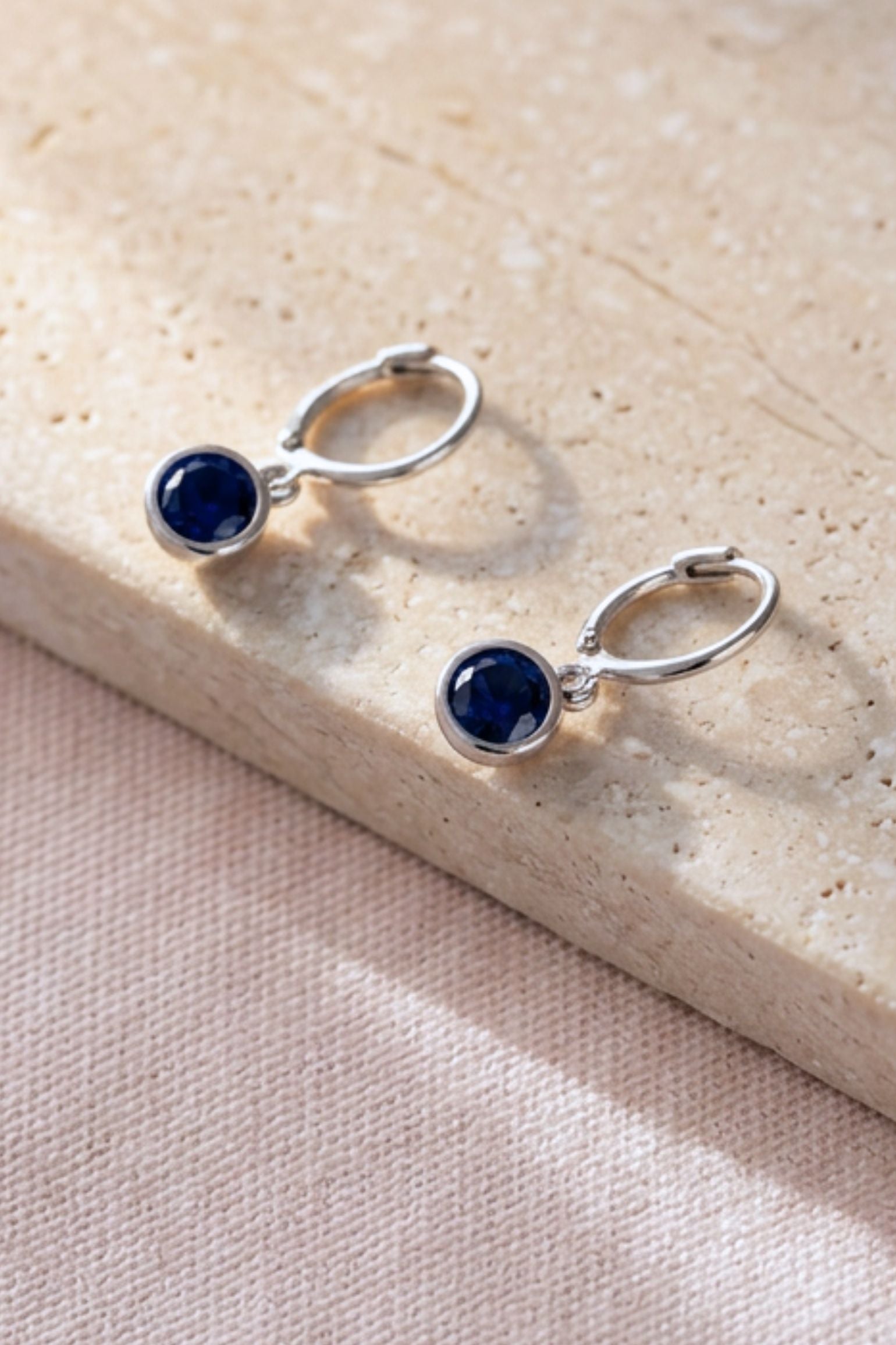 sterling-silver-cz-huggie-hoops-in-silver-midnight-blue