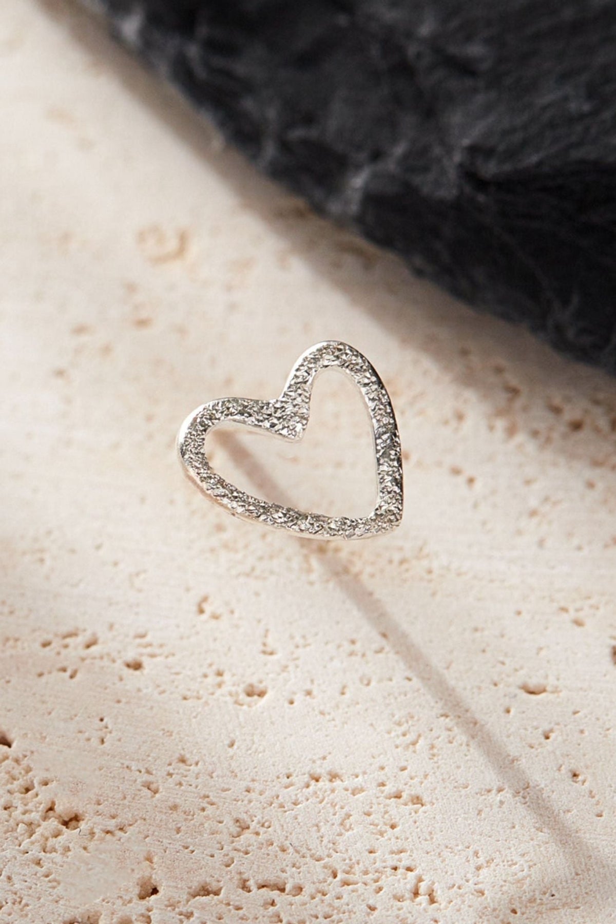 sterling-silver-frosted-open-heart-stud-earrings-surface-closeup