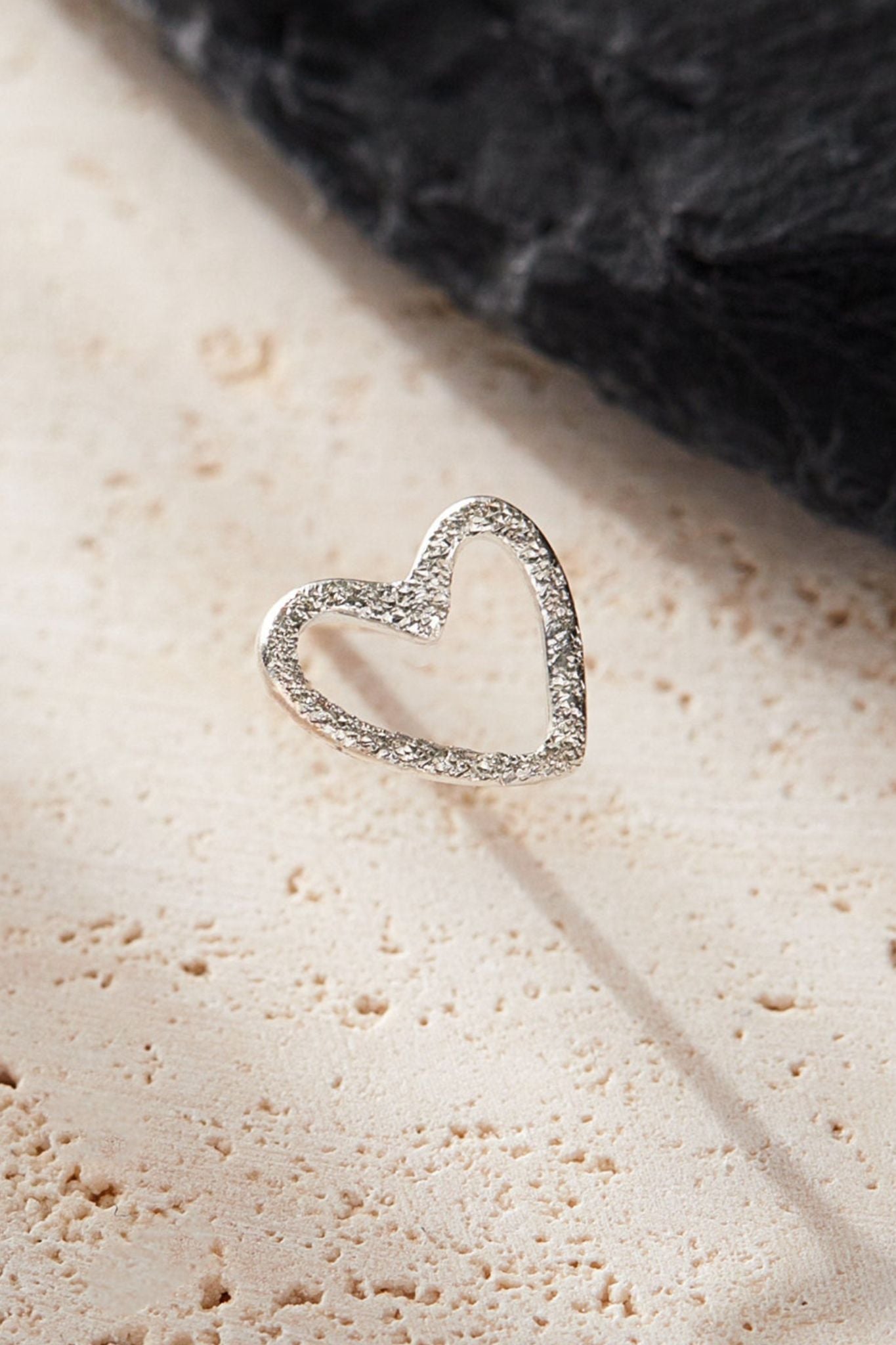 sterling-silver-frosted-open-heart-stud-earrings-surface-closeup