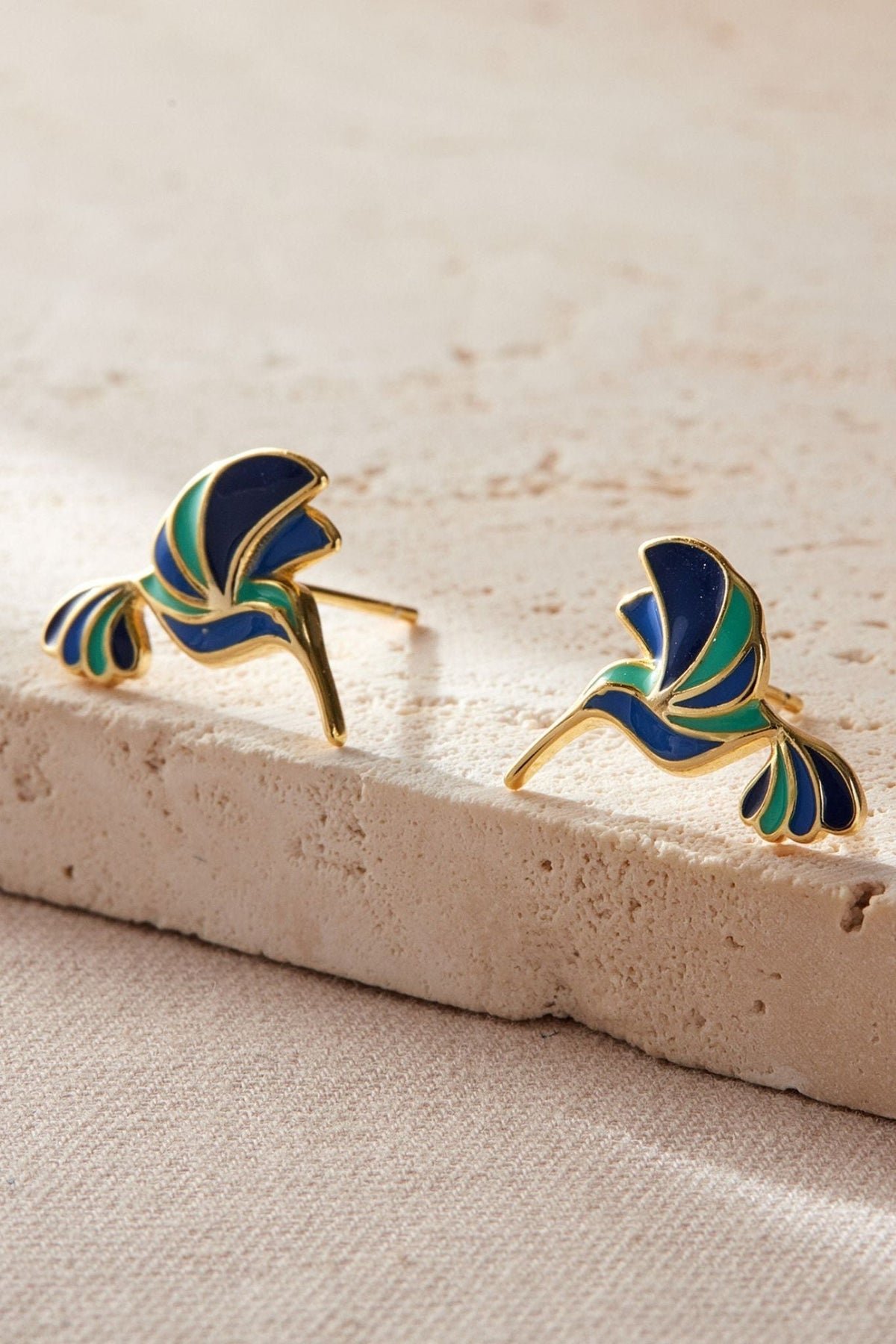 sterling-silver-blue-hummingbird-studs-in-gold-closeup