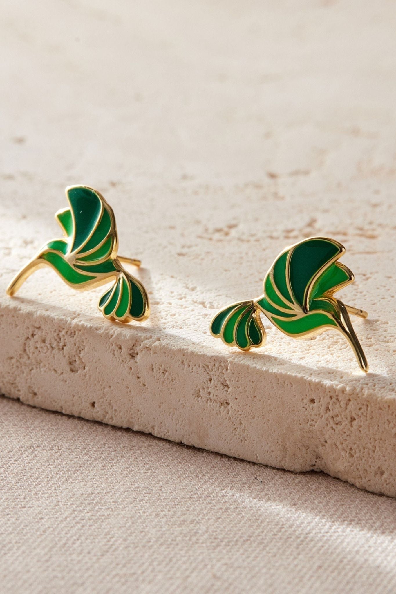 sterling-silver-green-hummingbird-studs-in-gold-closeup