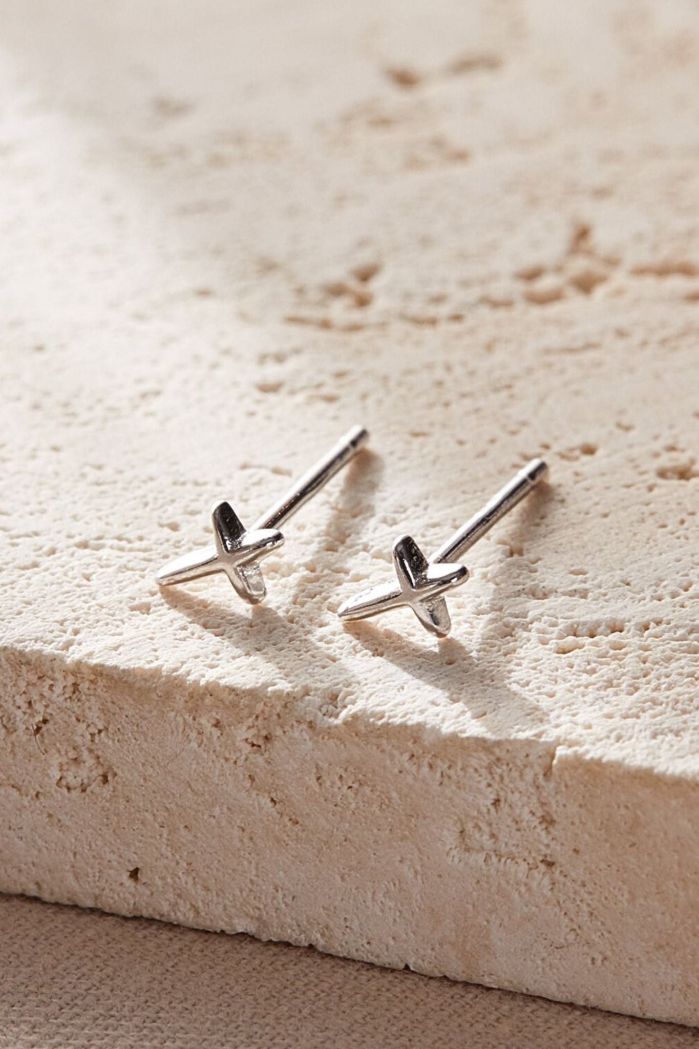 sterling-silver-tiny-cross-studs-in-silver-closeup