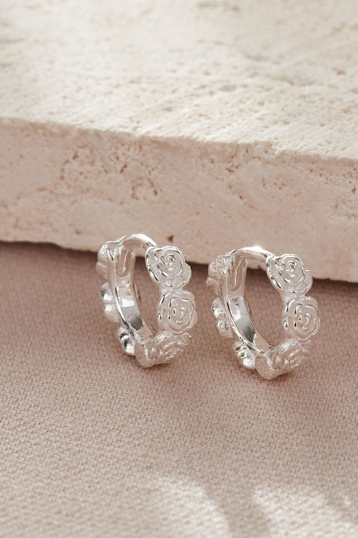sterling-silver-rose-huggie-hoops-closeup