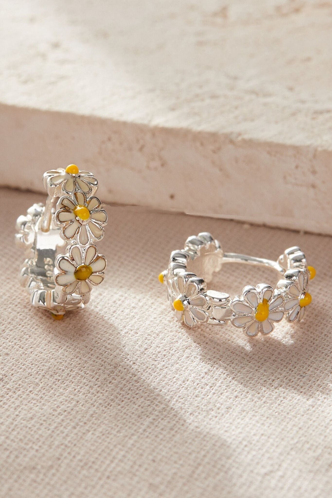 silver-daisy-huggie-hoops