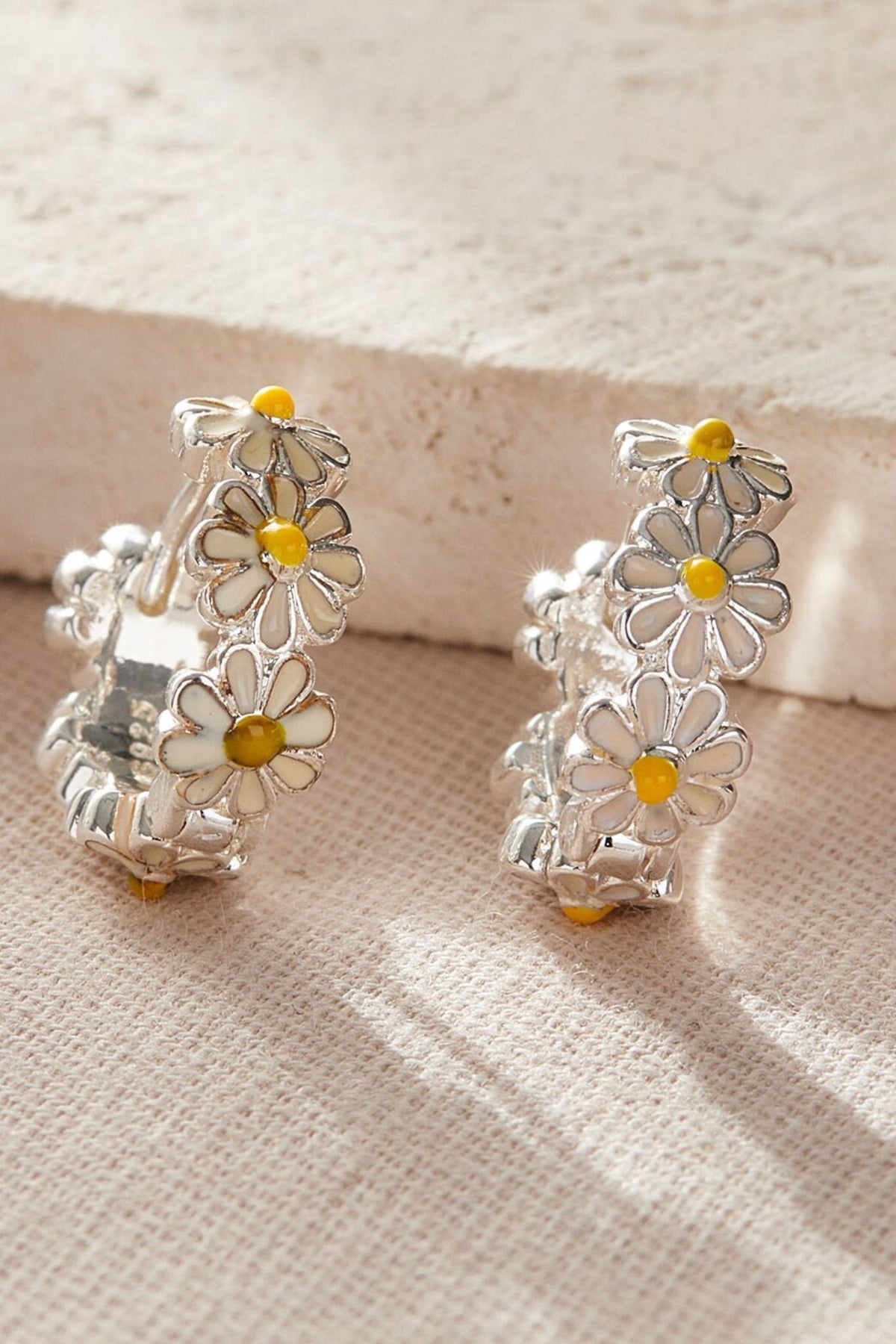 silver-daisy-huggie-hoops-closeup