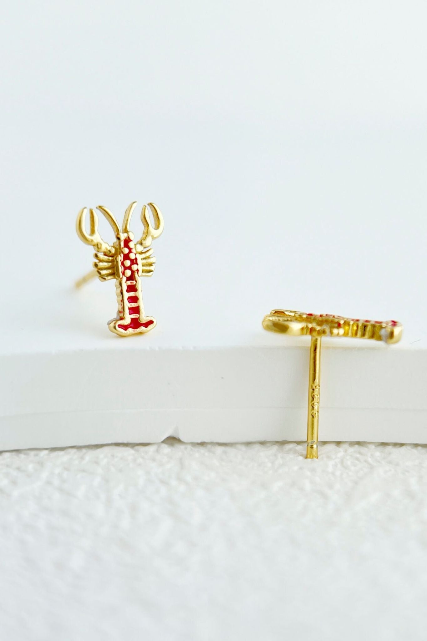 sterling-silver-lobster-studs-in-gold-closeup
