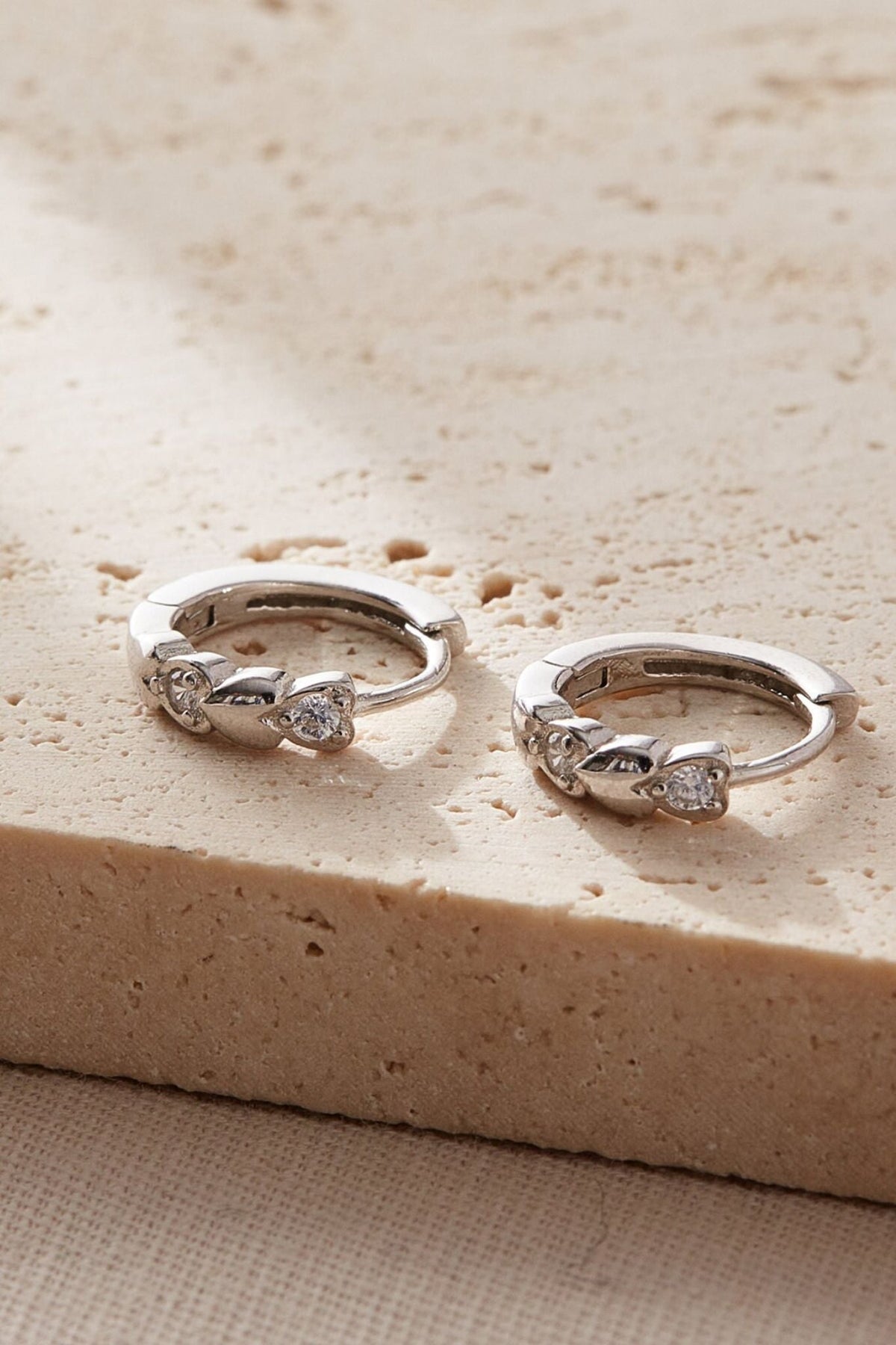sterling-silver-cz-sparkly-heart-huggie-hoops-closeup