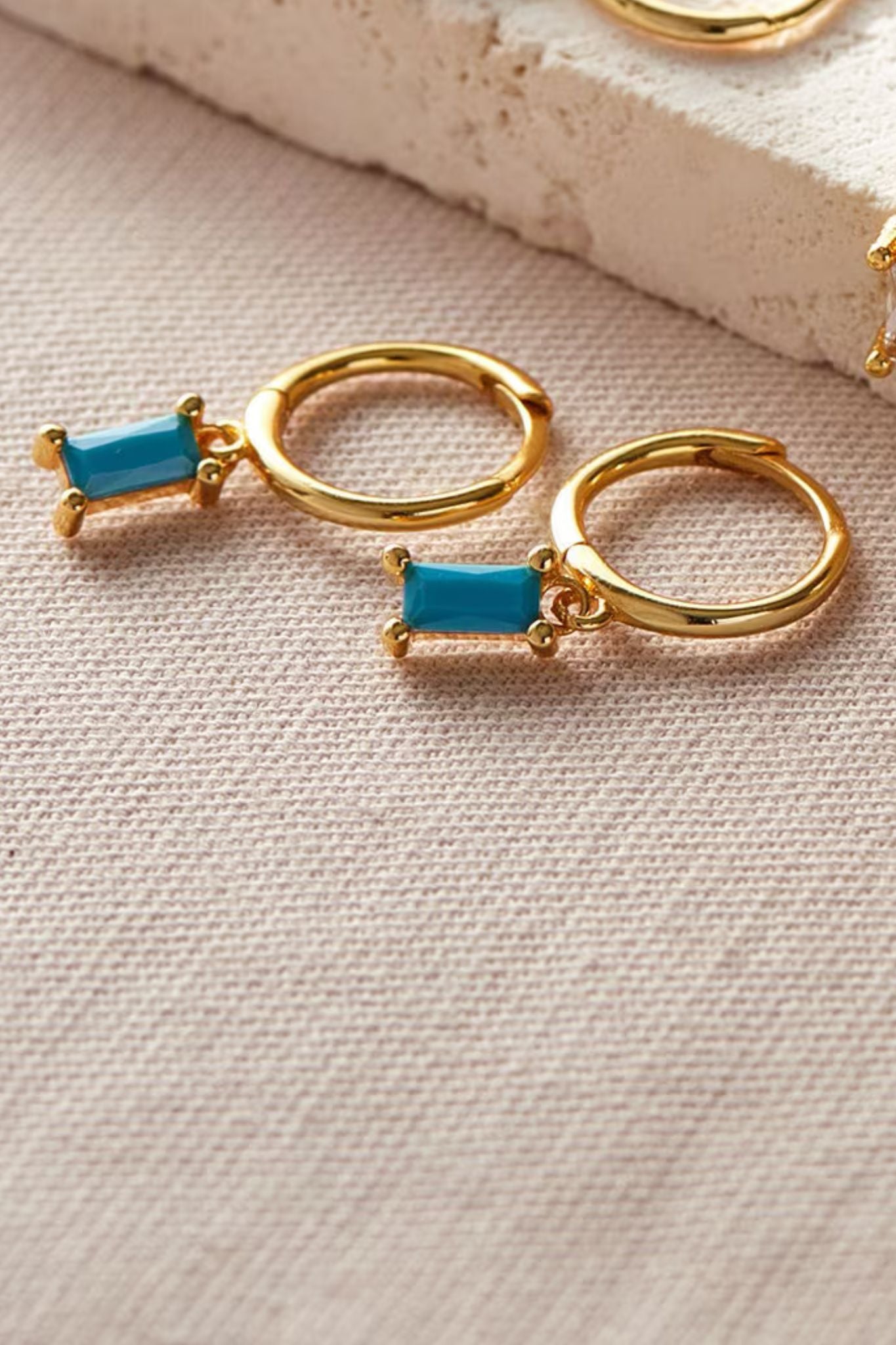 sterling-silver-cz-baguette-hoops-in-gold-blue