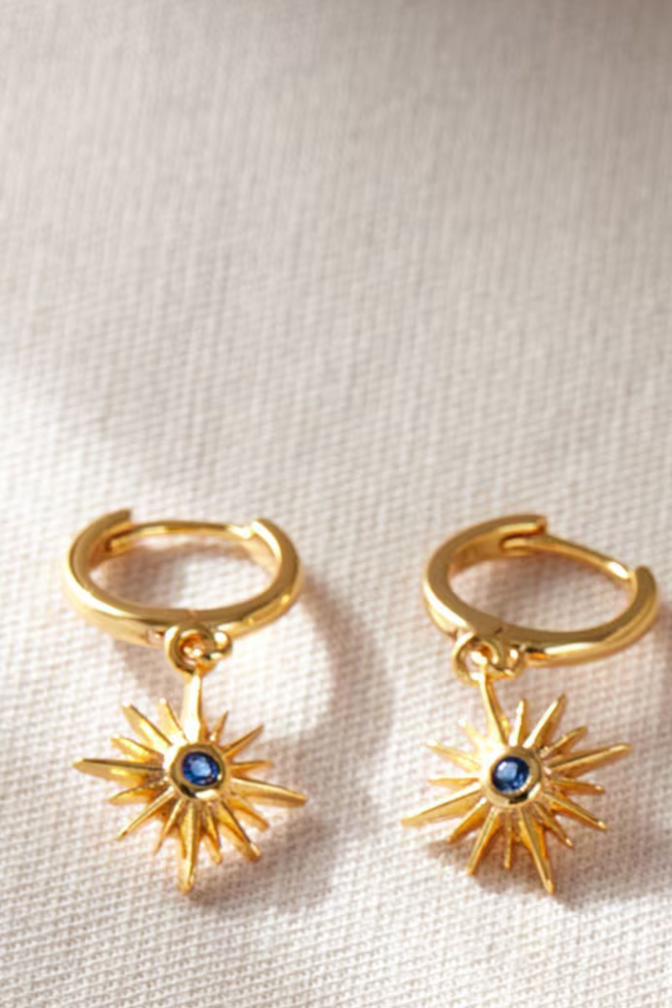 sterling-silver-north-star-hoops-in-gold-blue