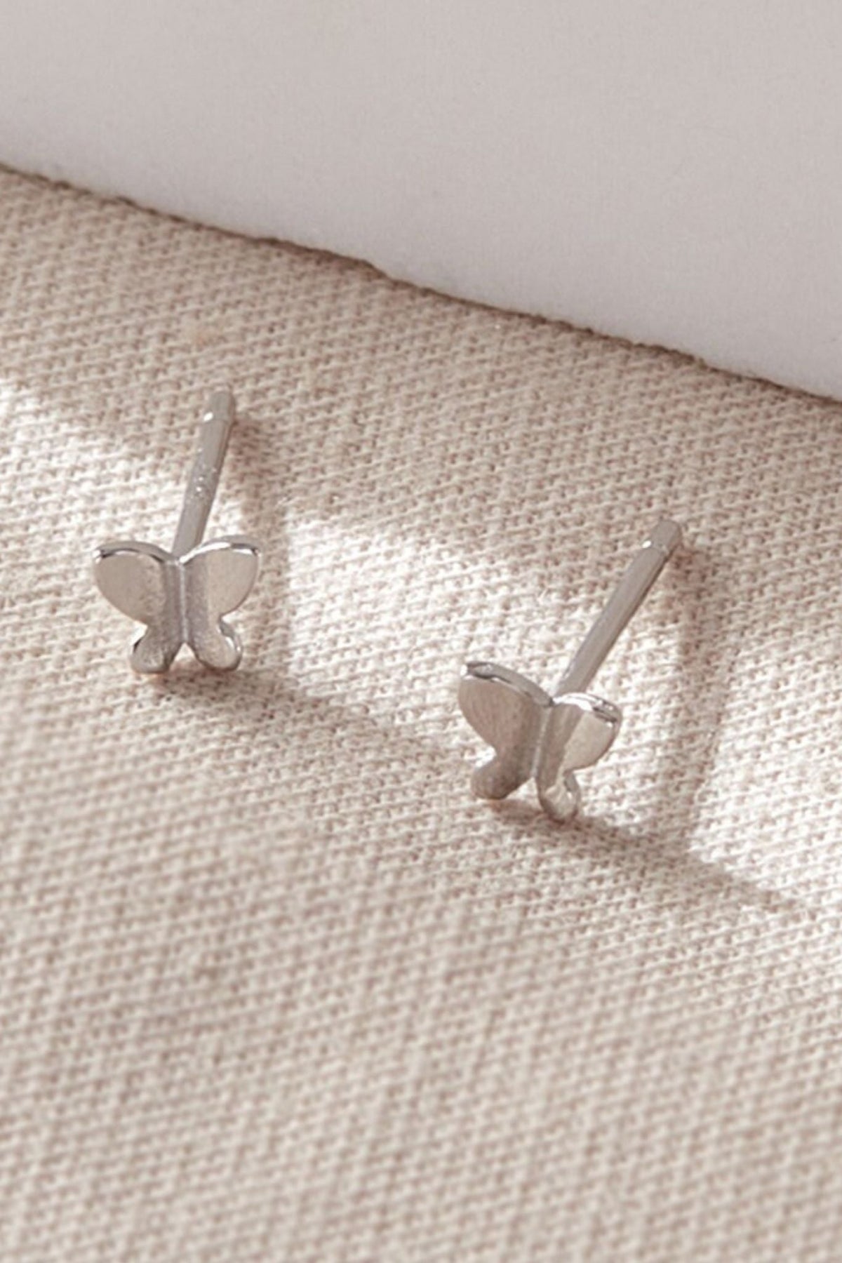 close up of the sterling silver dainty butterfly stud earrings