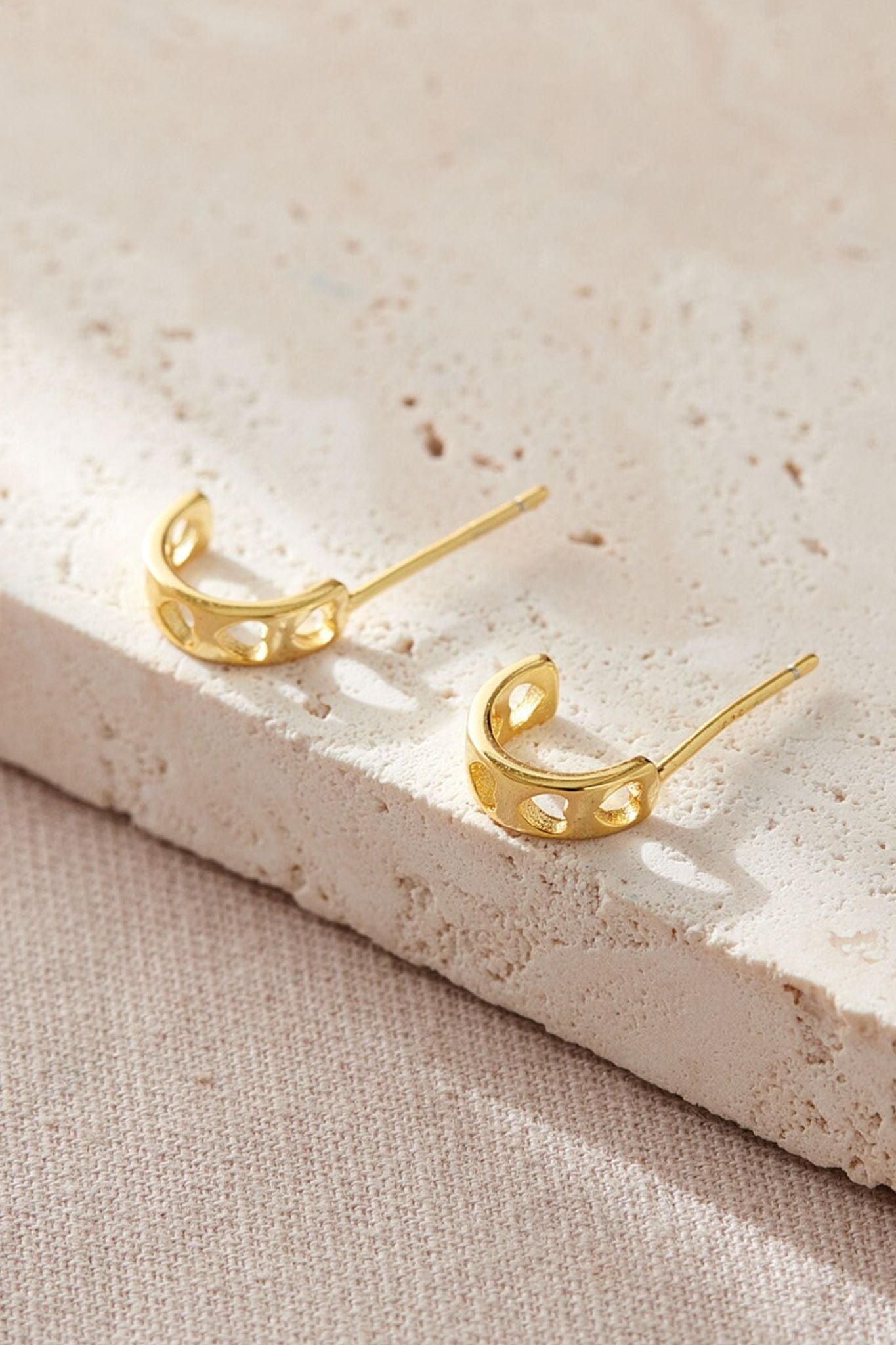 sterling-silver-heart-half-hoops-in-gold-closeup