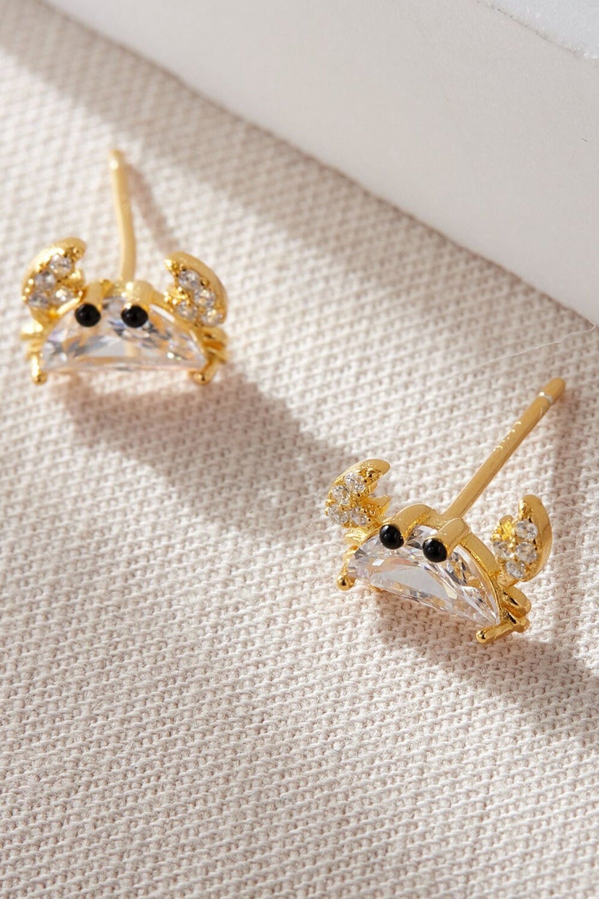 sterling-silver-cz-crab-studs-in-gold-closeup