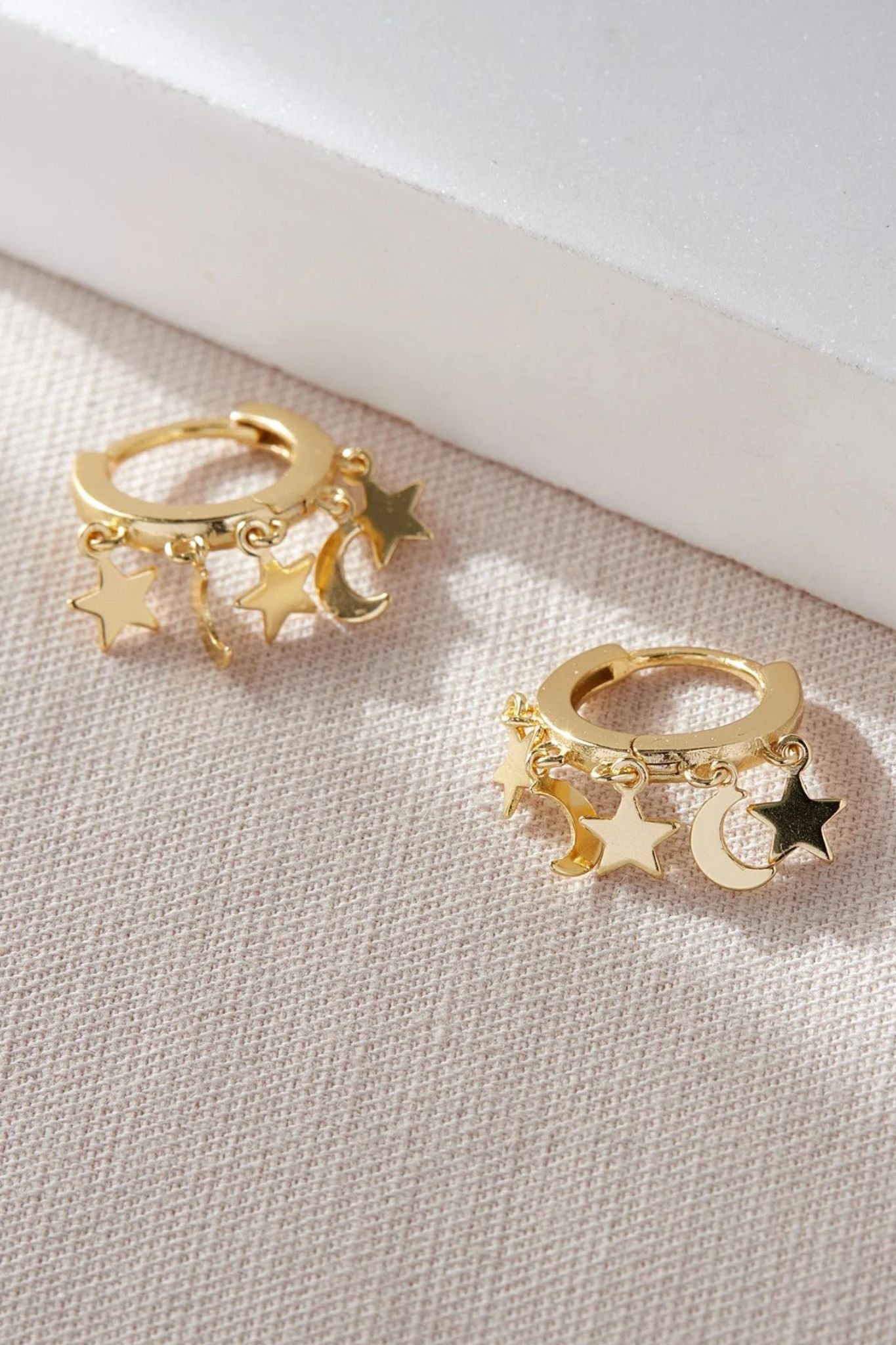 sterling-silver-star-moon-charm-hoops-in-gold