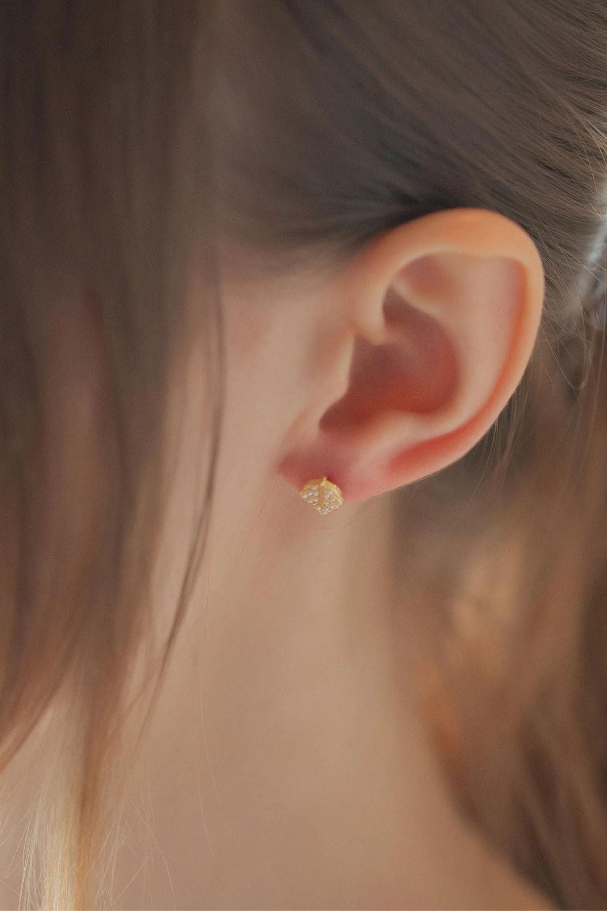 sterling-silver-sparkly-leaf-studs-in-gold-model