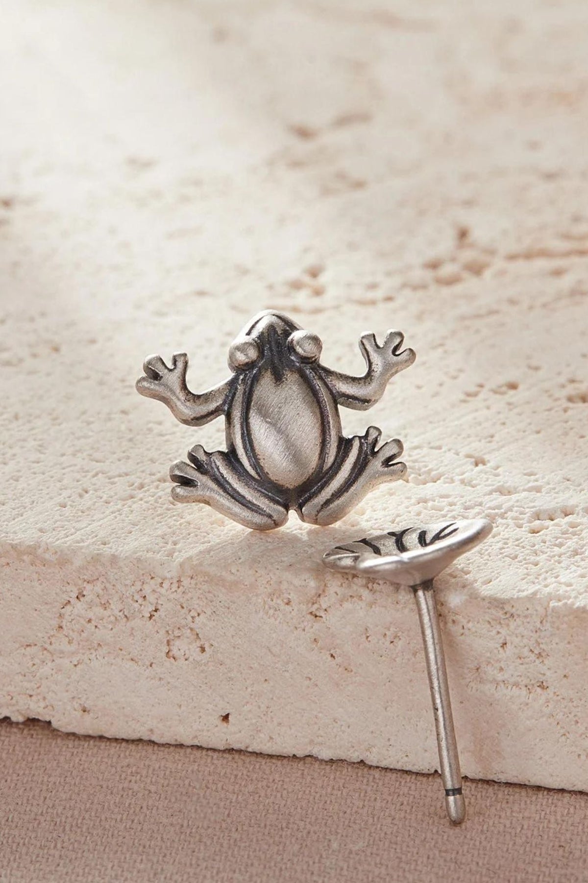close up of the frog stud earring