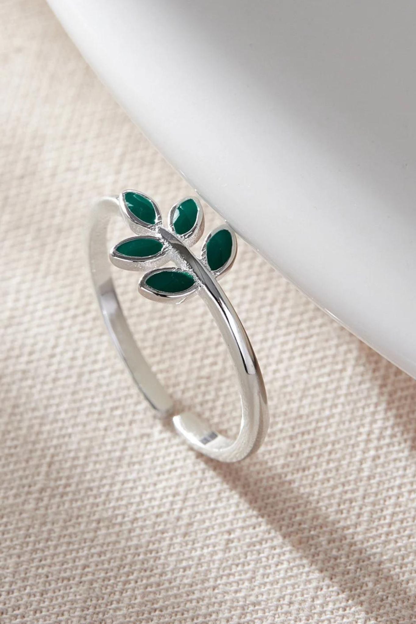 close up of the green olive leaf silver ring
