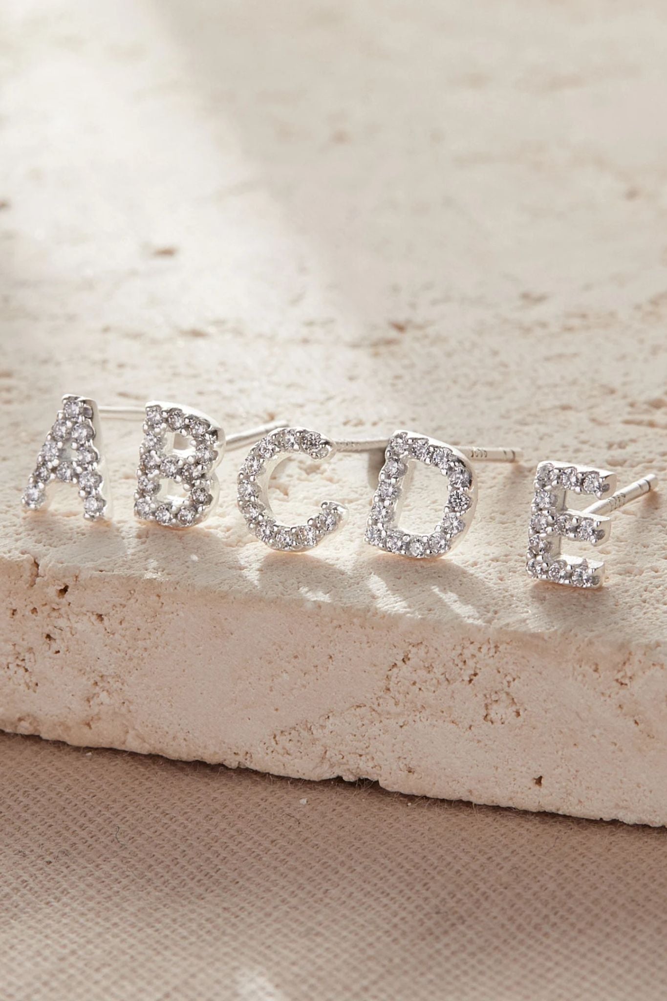 sterling-silver-cz-alphabet-studs-in-silver-single-earrings-closeup