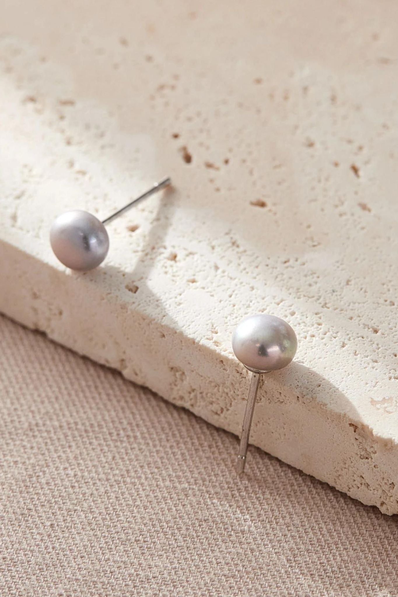 sterling-silver-pearl-studs-in-silver-closeup
