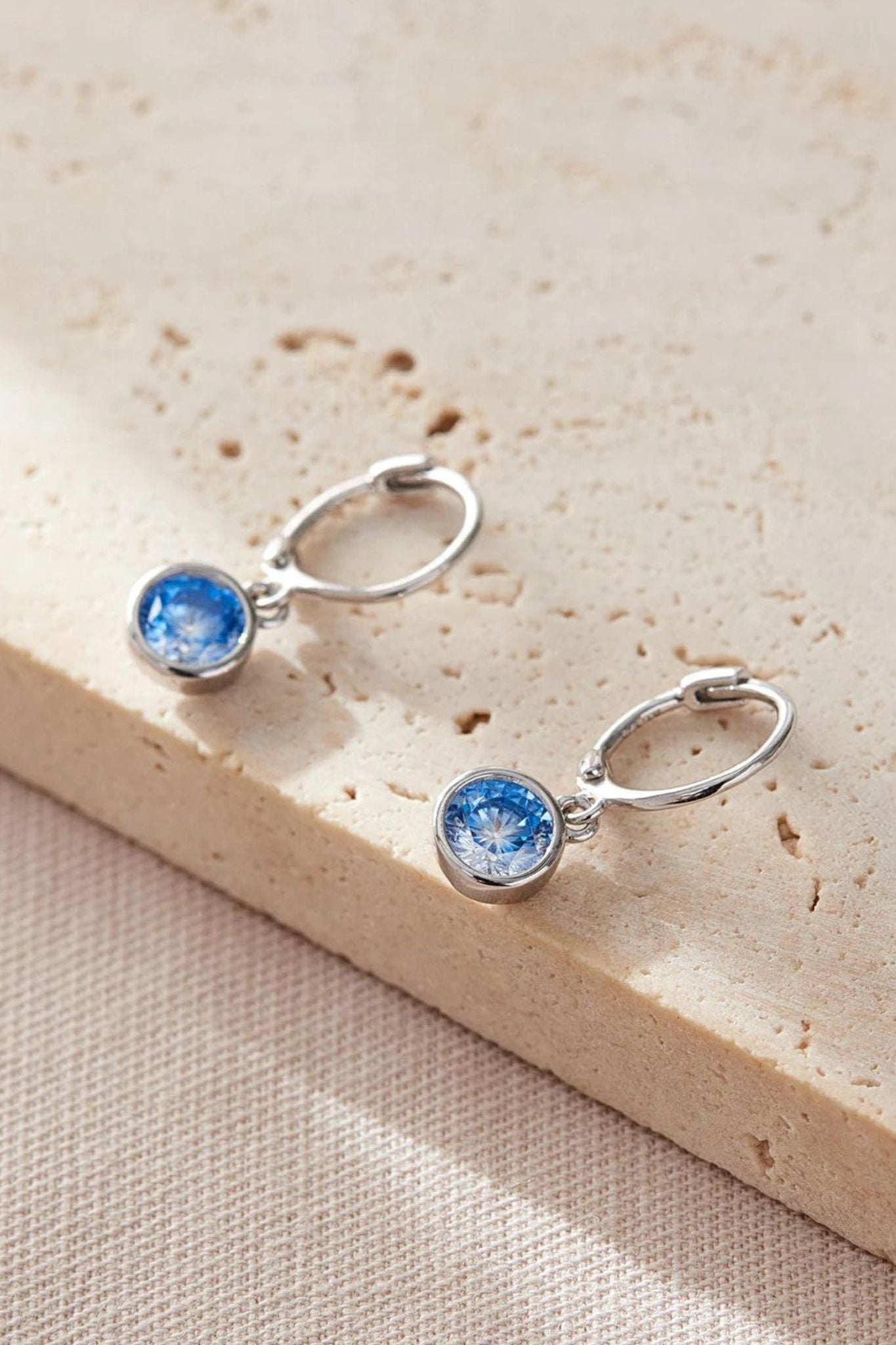sterling-silver-cz-huggie-hoops-in-silver-light-blue