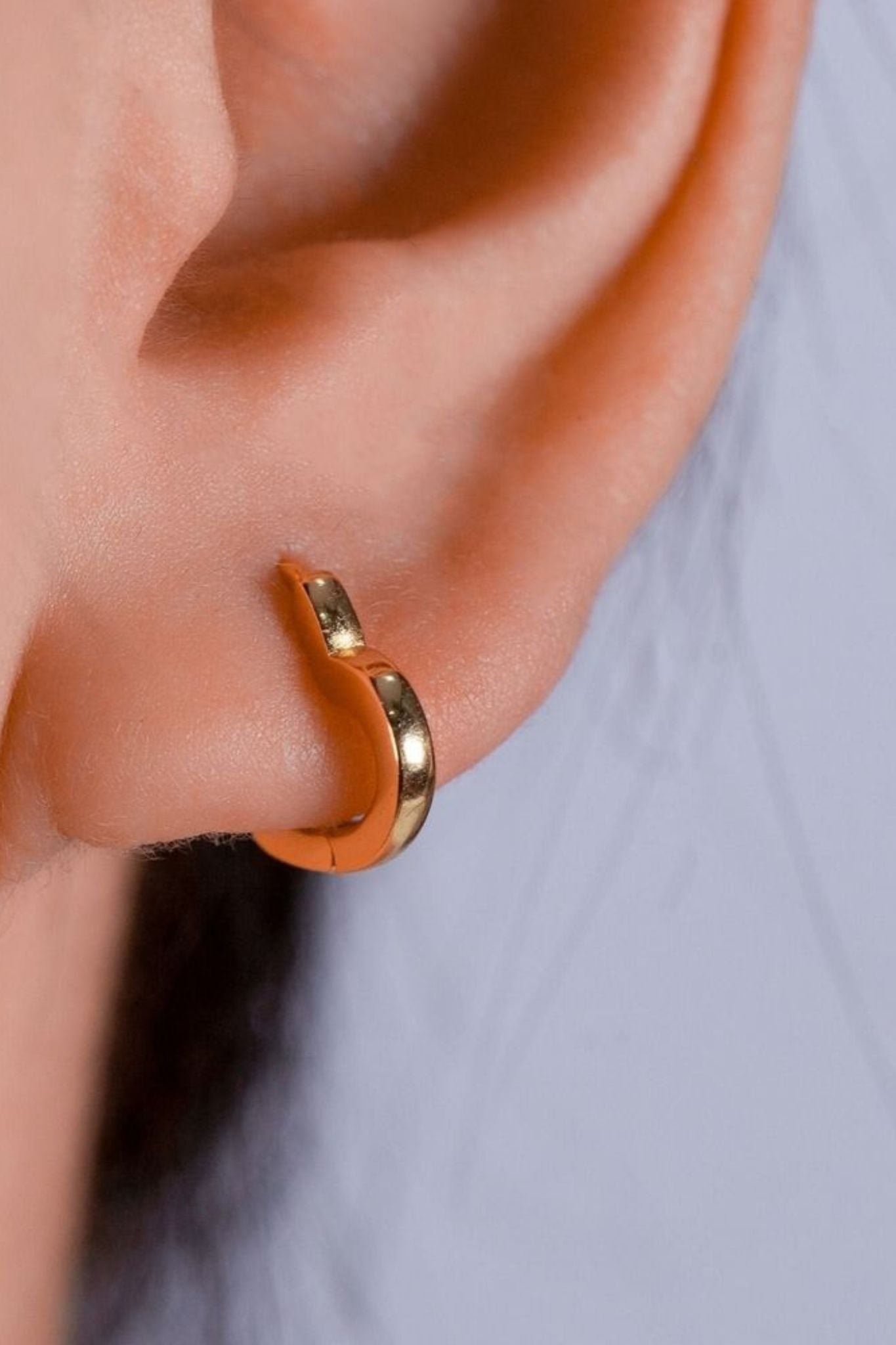 sterling-silver-heart-huggie-hoops-in-gold-model