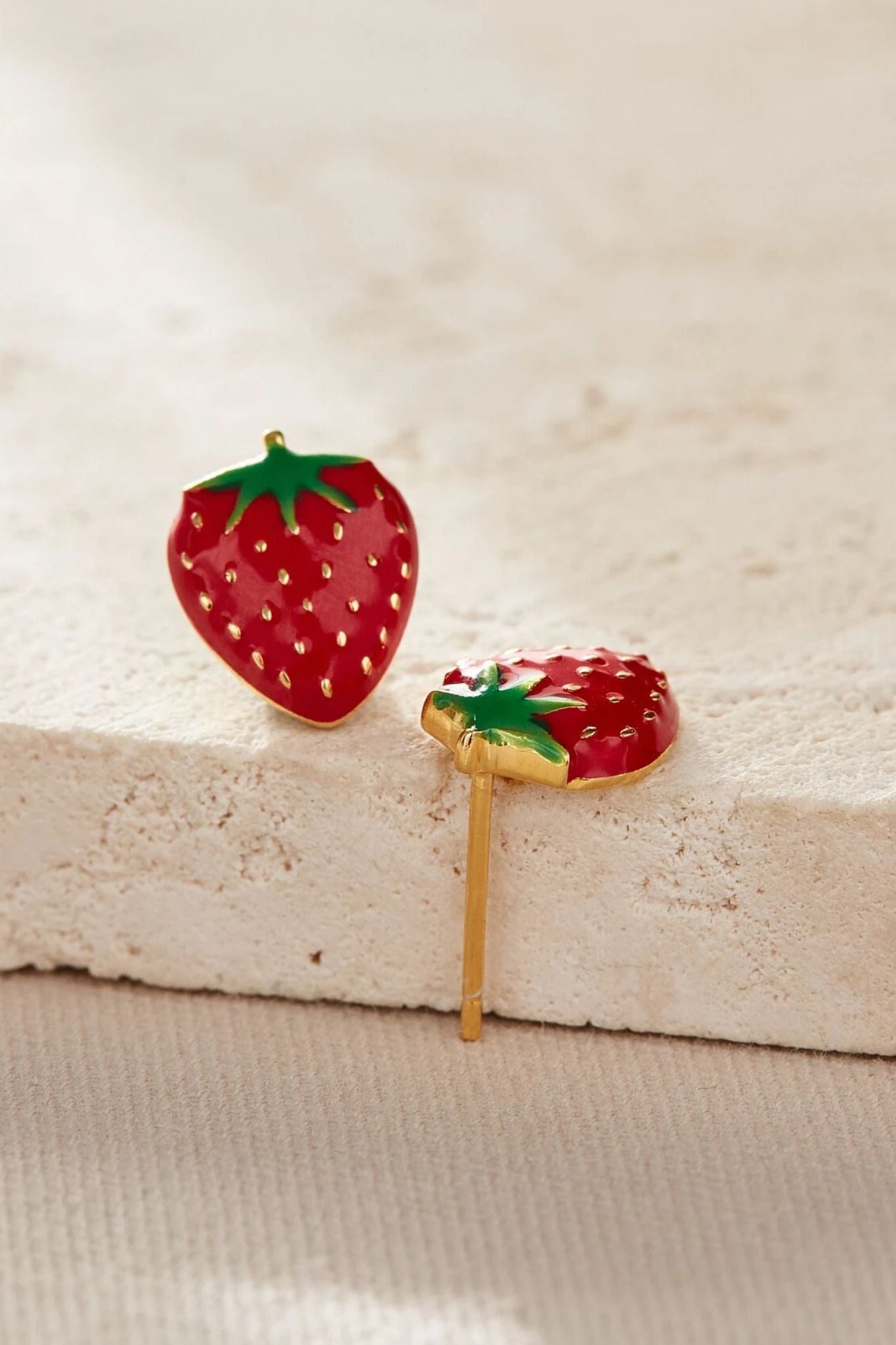 sterling-silver-strawberry-studs-in-gold-closeup