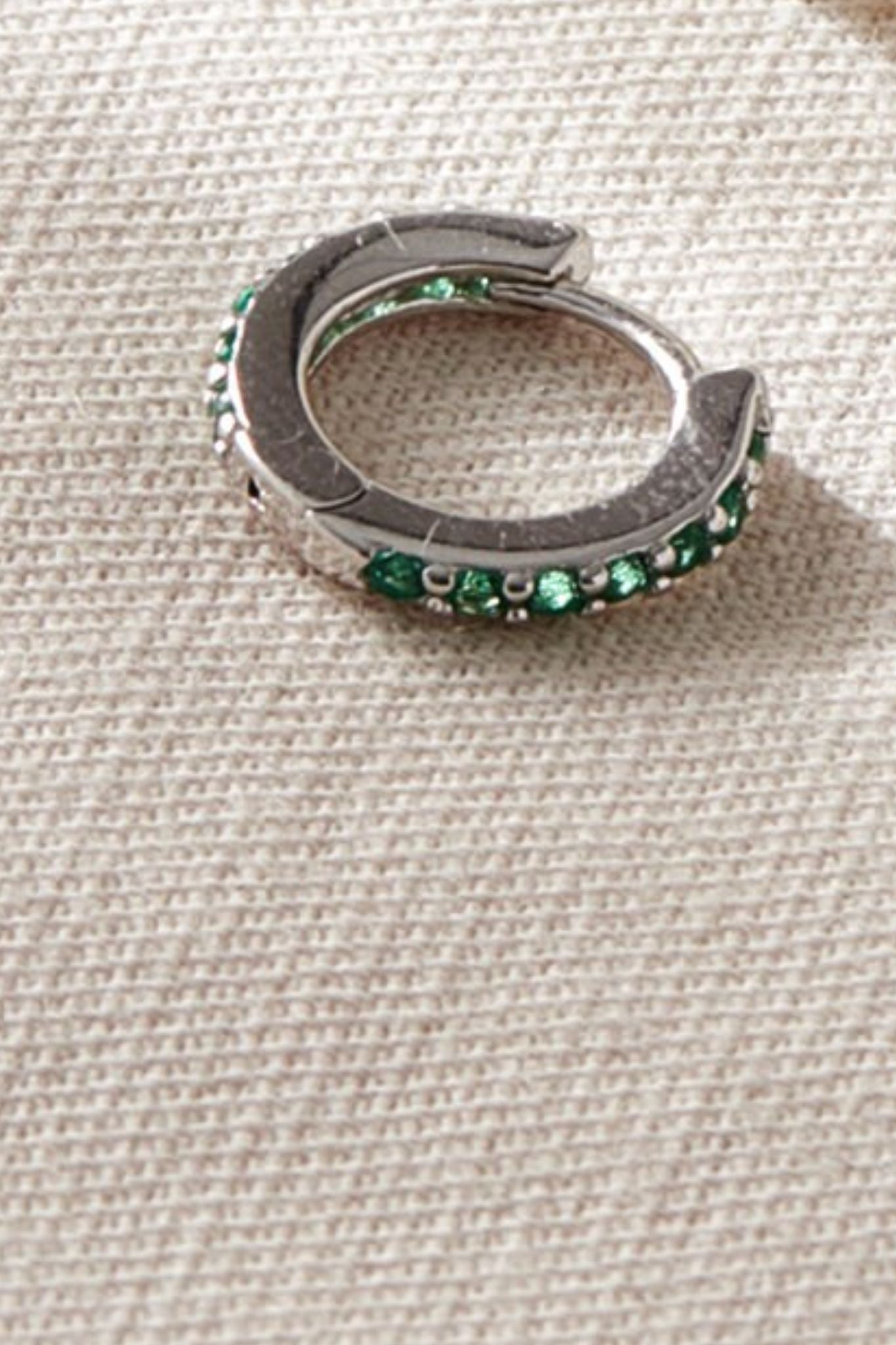 sterling-silver-cz-huggie-hoops-in-silver-green-closeup