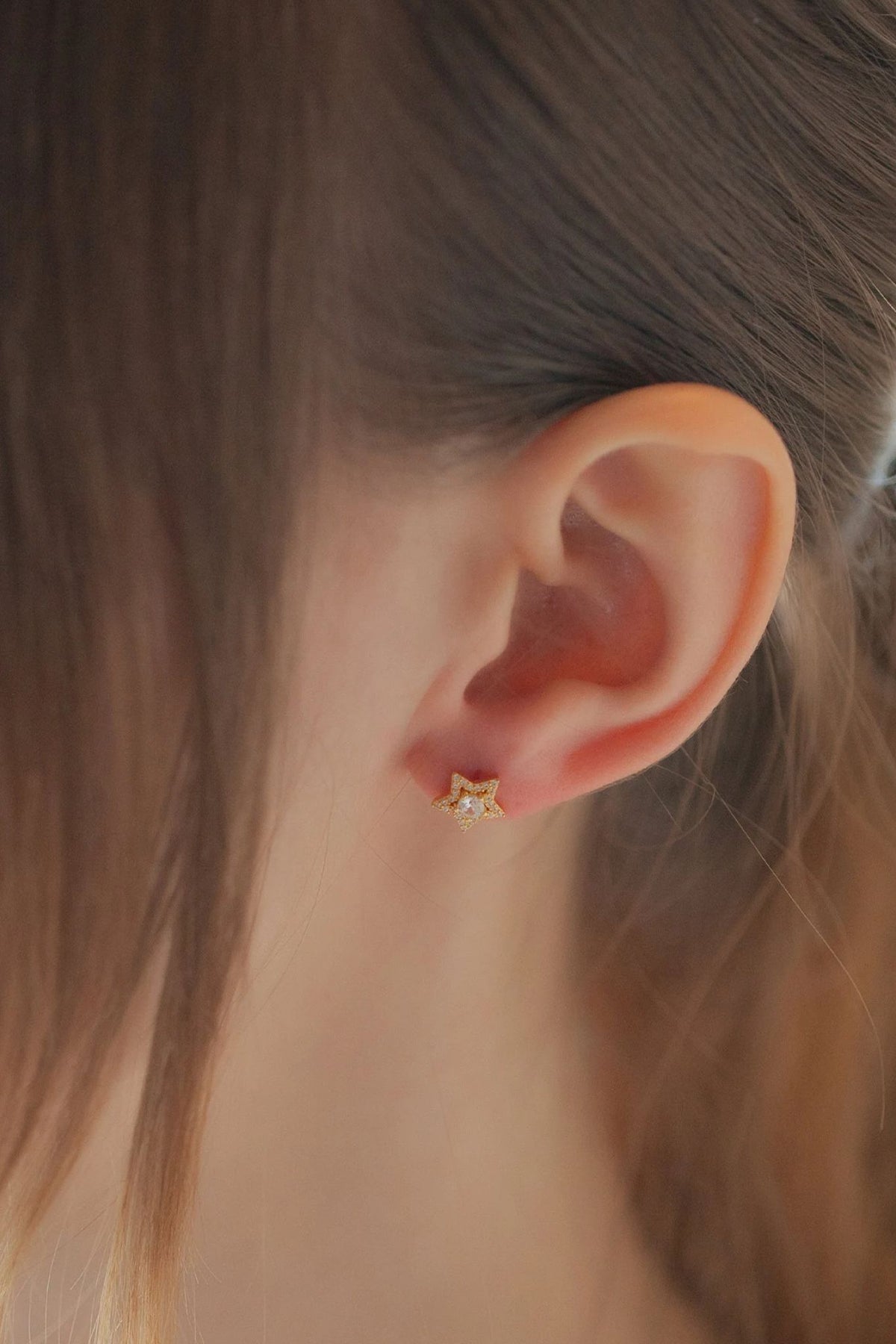 sterling-silver-cz-star-studs-in-gold-model