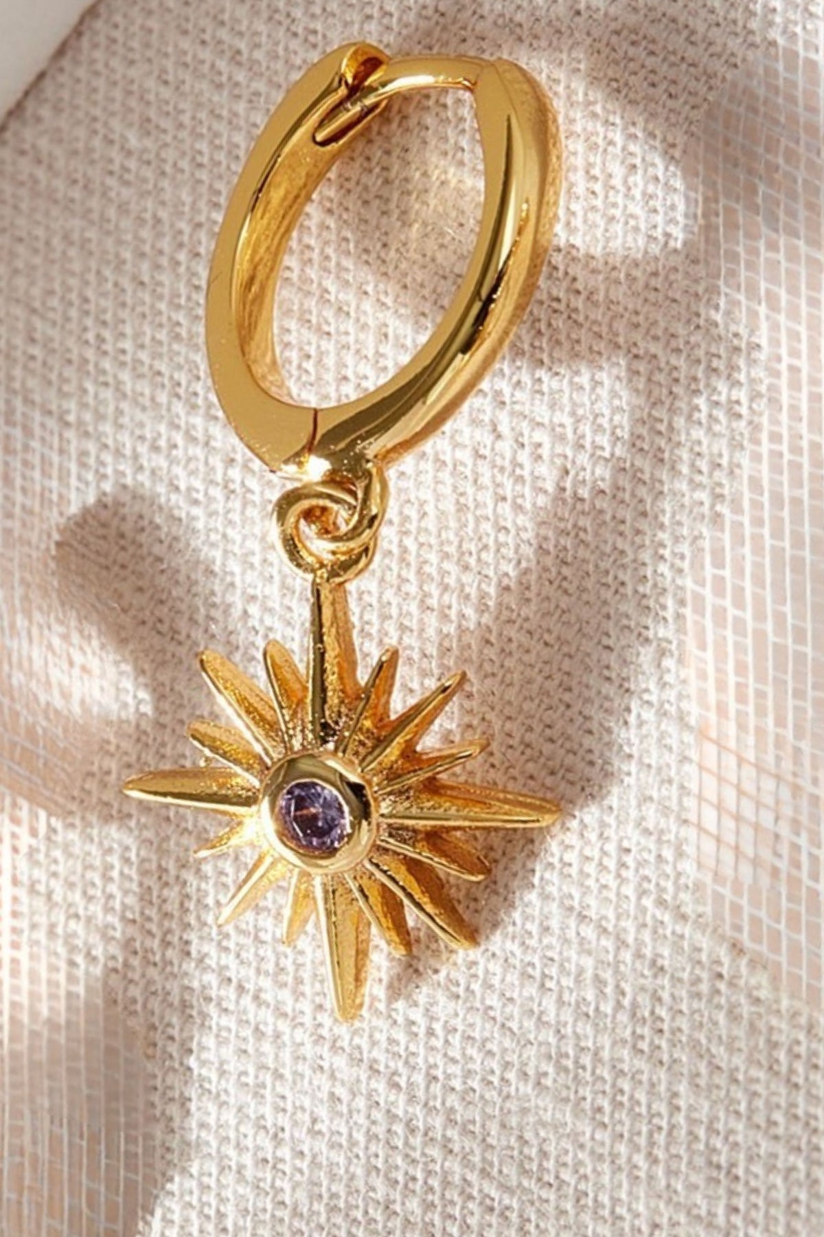 sterling-silver-north-star-hoops-in-gold-purple-closeup